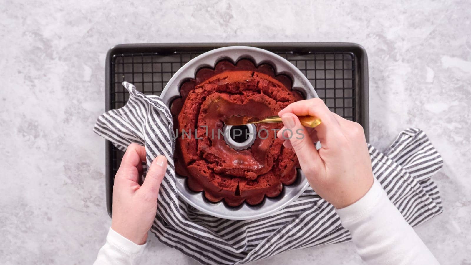 Flat lay. Step by step. Cooling freshly baked red velvet bundt cake on a kitchen drying rack.