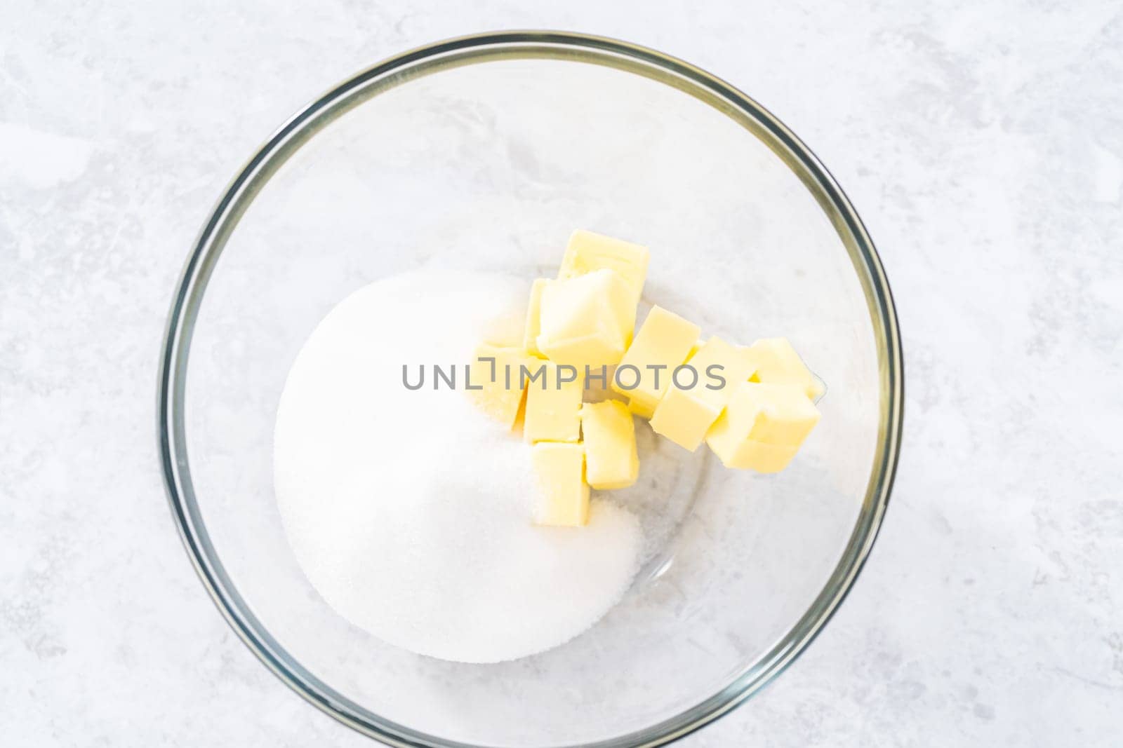 Mixing ingredients in a glass mixing bowl to bake July 4th bundt cake with chocolate stars.