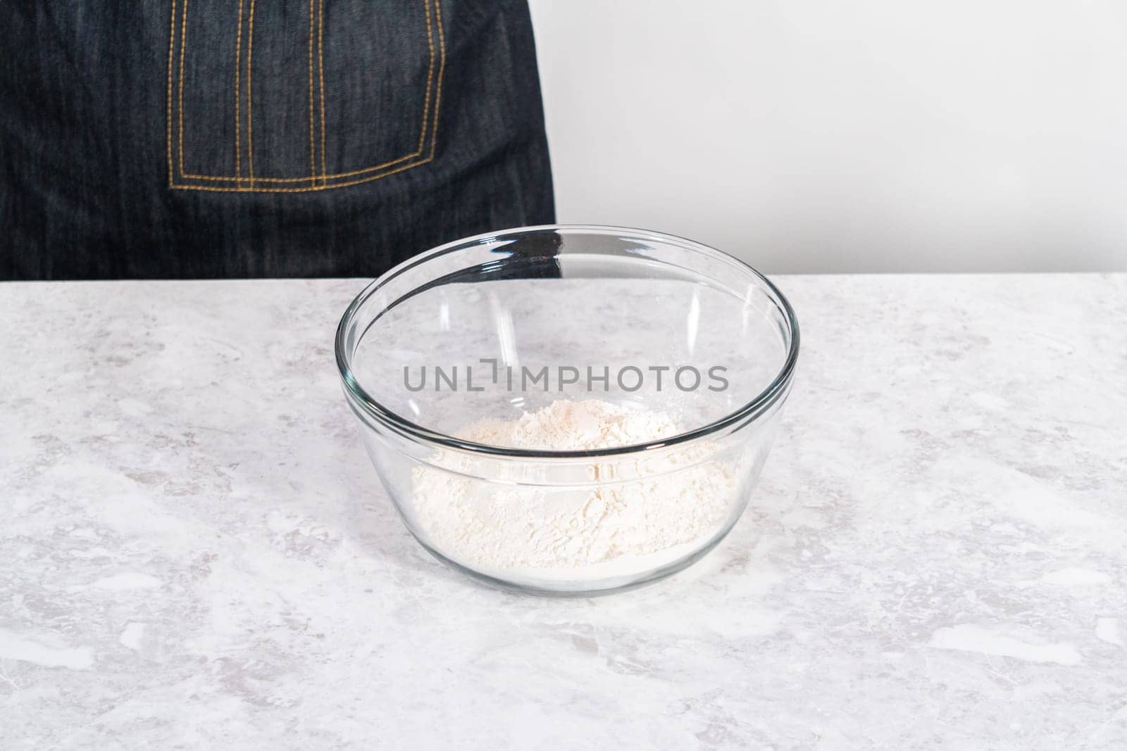 Mixing ingredients in a glass mixing bowl to bake July 4th bundt cake with chocolate stars.