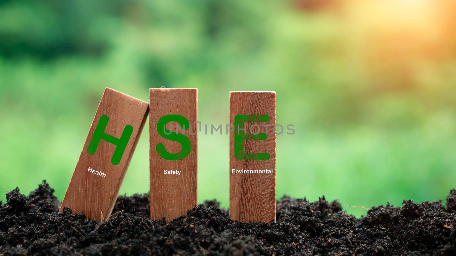 Wooden sticks stacked with HSE concept lettering on nature background. Concept of HSE Health Safety Environment Education Industry.words HSE on a woodblock It is an idea for health safety environment for business and organization. by Unimages2527
