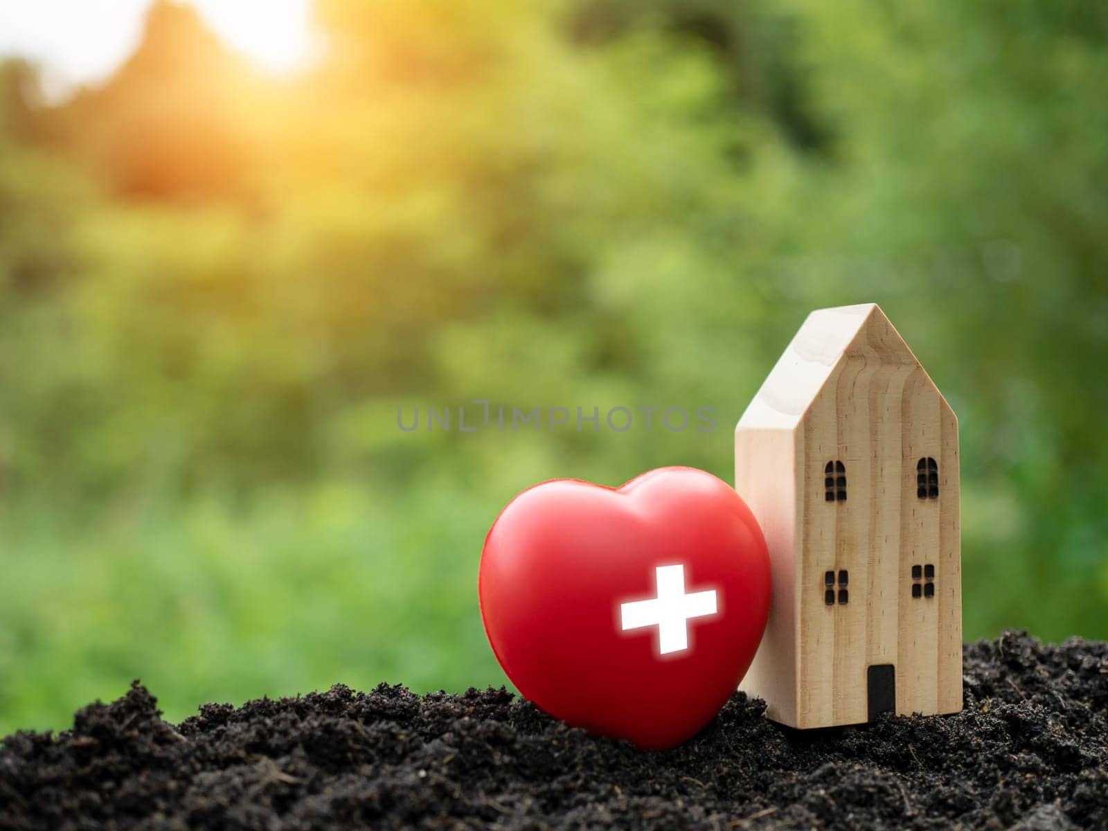 The concept of health insurance and medical welfare. Model wooden house and red heart with plus icon. Health insurance and access to health care. health care planning by Unimages2527