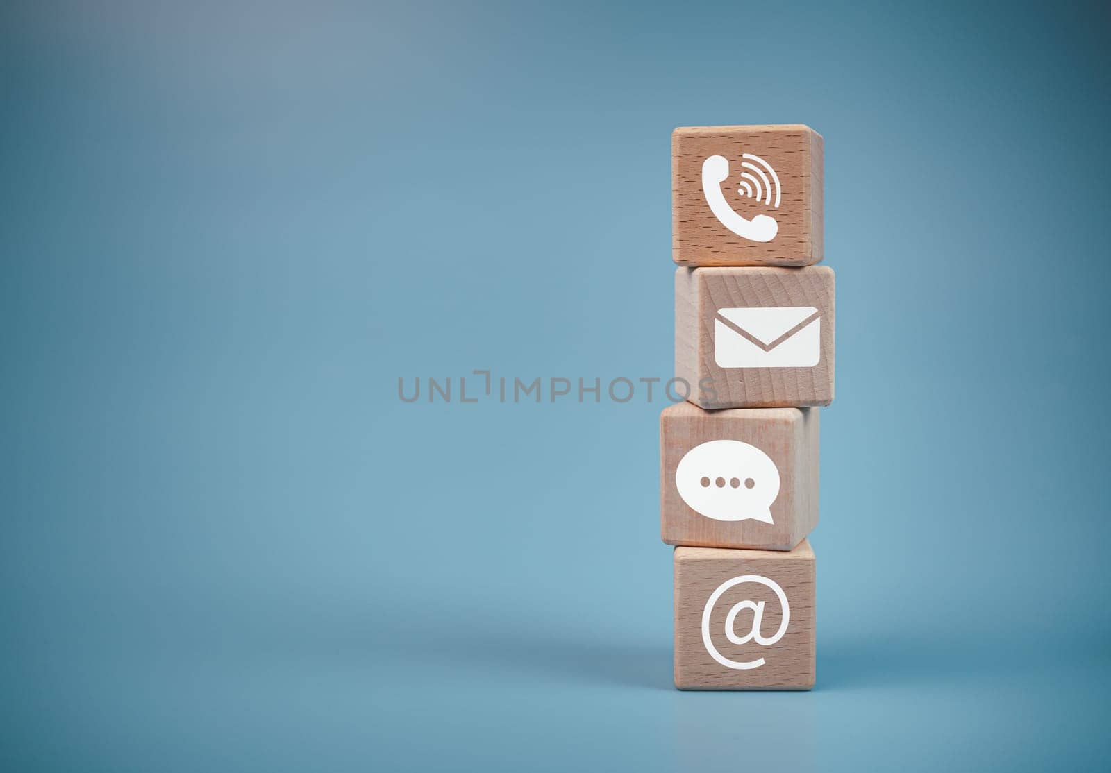 Stacked wooden blocks and communication icons. Website page, contact us or email marketing concept, customer support hotline, contact us, email, phone, address, chat message icon.