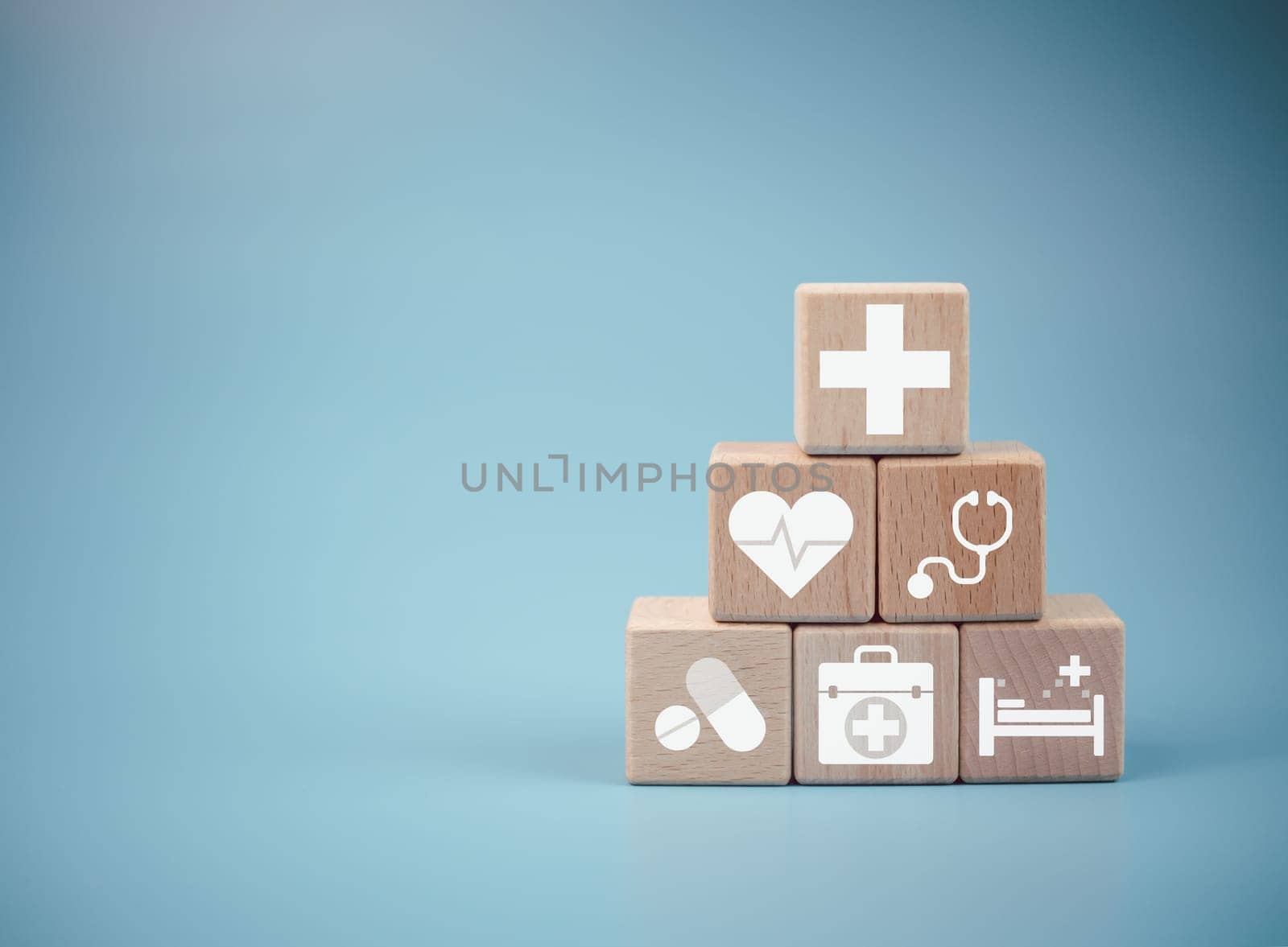 Wooden cube blocks stacked with icons. Health and Medicine Concepts.