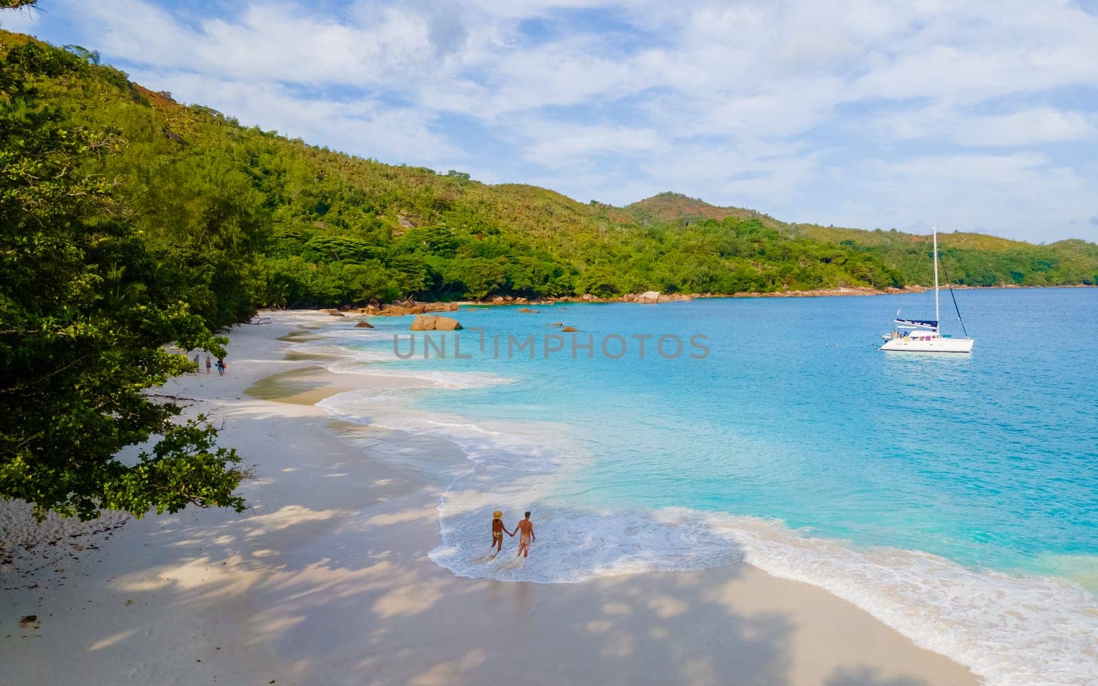 Anse Lazio Praslin Seychelles, a young couple of men and women on a tropical beach during vacation by fokkebok