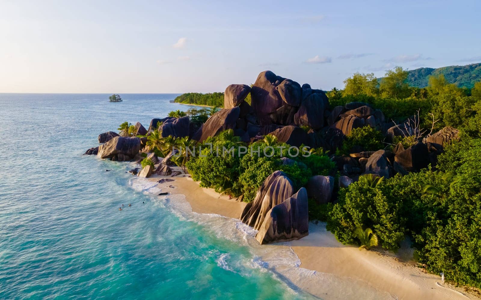 Anse Source d'Argent, La Digue Seychelles, a young couple of men and women on a tropical beach during a luxury vacation in Seychelles. Anse Source d'Argent, La Digue Seychelles