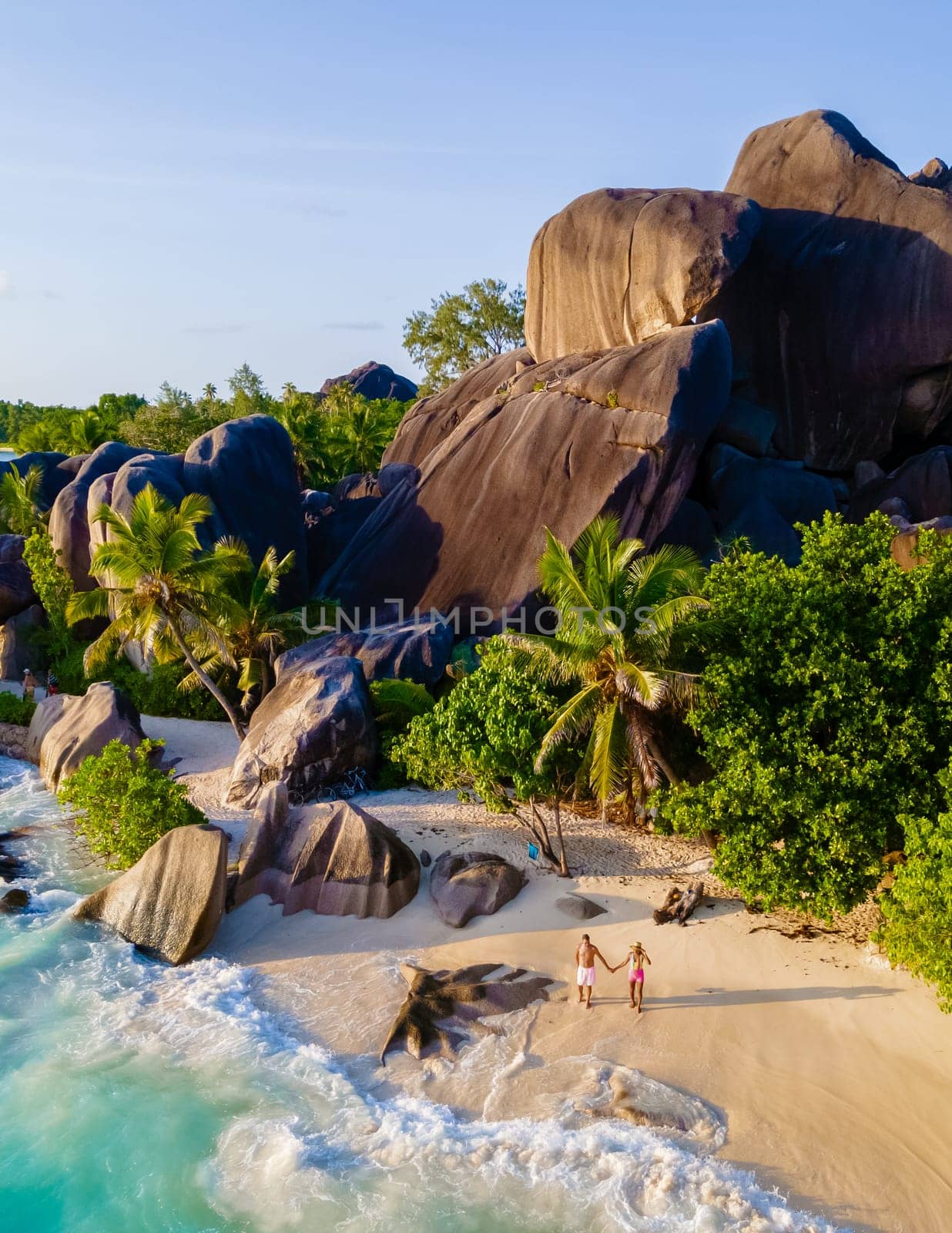 Anse Source d'Argent, La Digue Seychelles, a young couple of men and women on a tropical beach by fokkebok