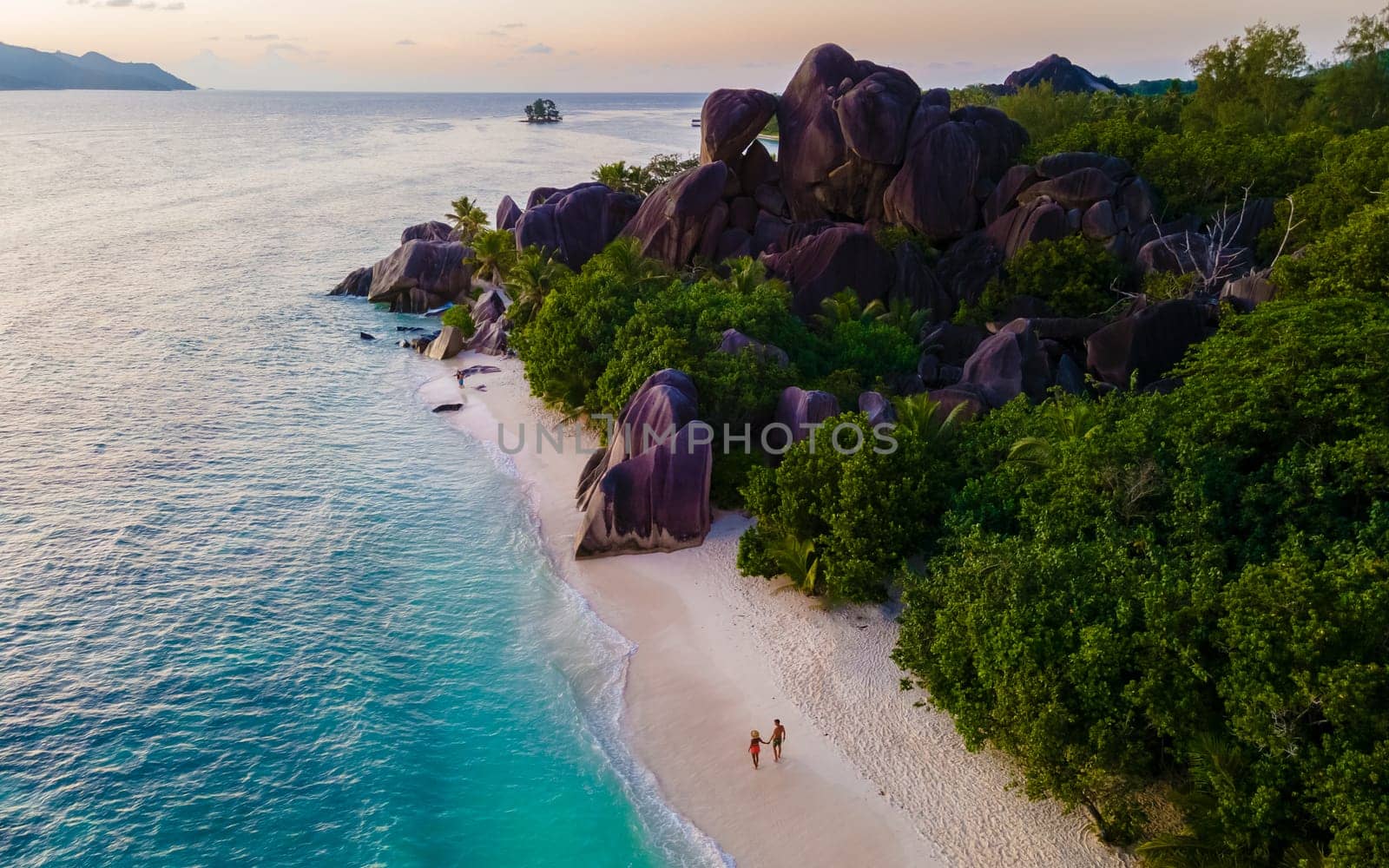 Anse Source d'Argent, La Digue Seychelles, a young couple of men and women on a tropical beach by fokkebok