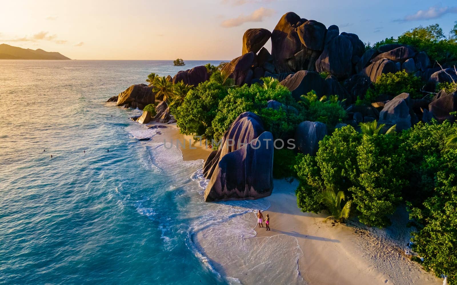 Anse Source d'Argent, La Digue Seychelles, a young couple of men and women on a tropical beach by fokkebok