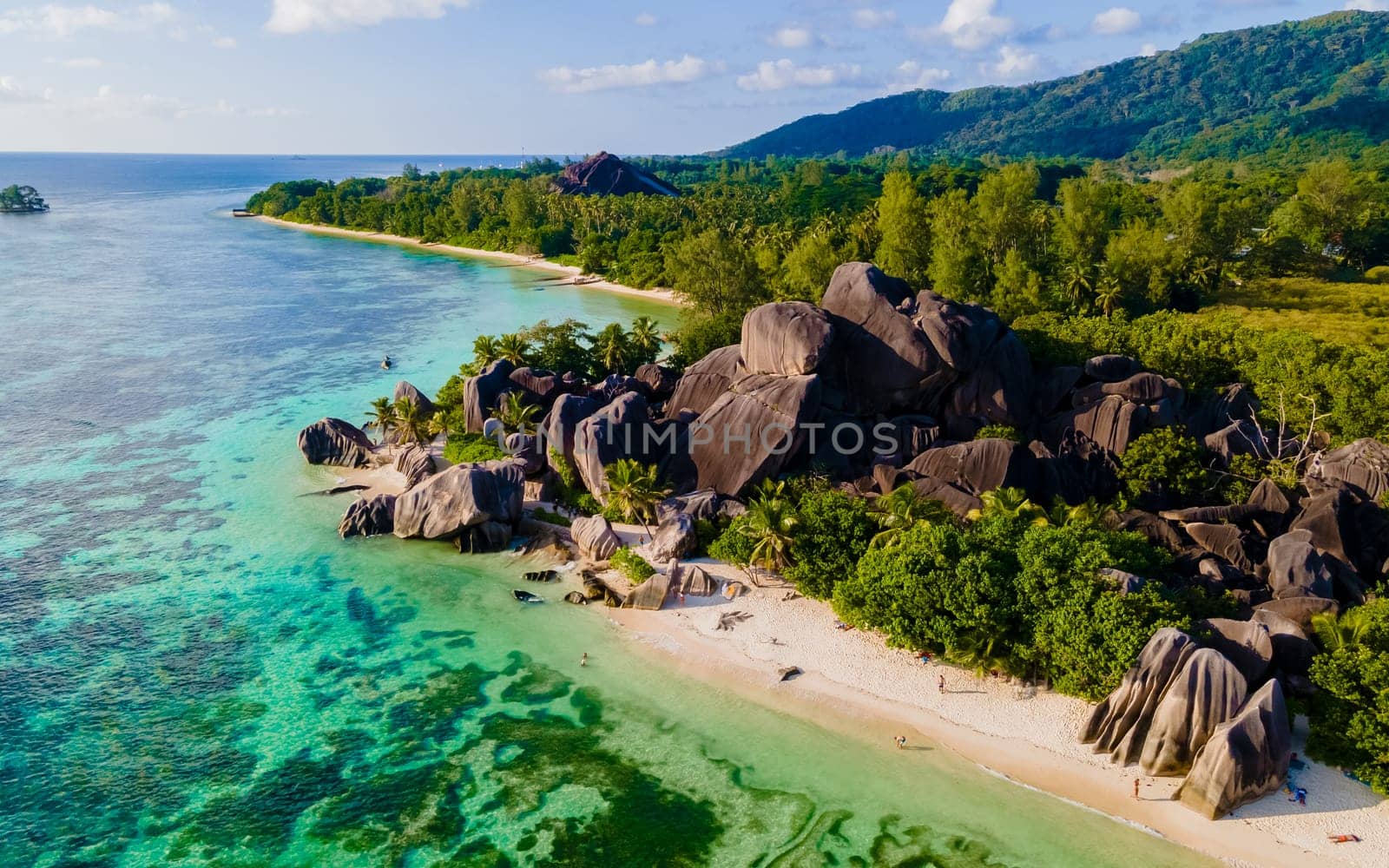 Anse Source d'Argent, La Digue Seychelles, a young couple of men and women on a tropical beach during a luxury vacation at the Seychelles. Tropical beach Anse Source d'Argent, La Digue Seychelles