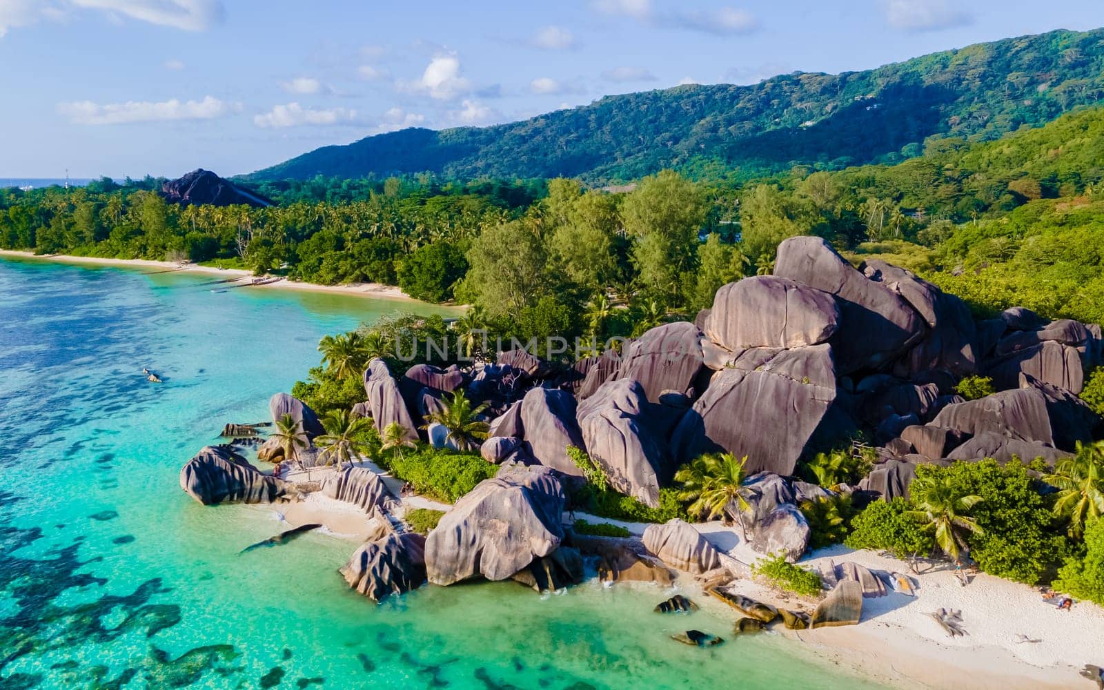 Anse Source d'Argent, La Digue Seychelles, a young couple of men and women on a tropical beach during a luxury vacation at the Seychelles. Tropical beach Anse Source d'Argent, La Digue Seychelles
