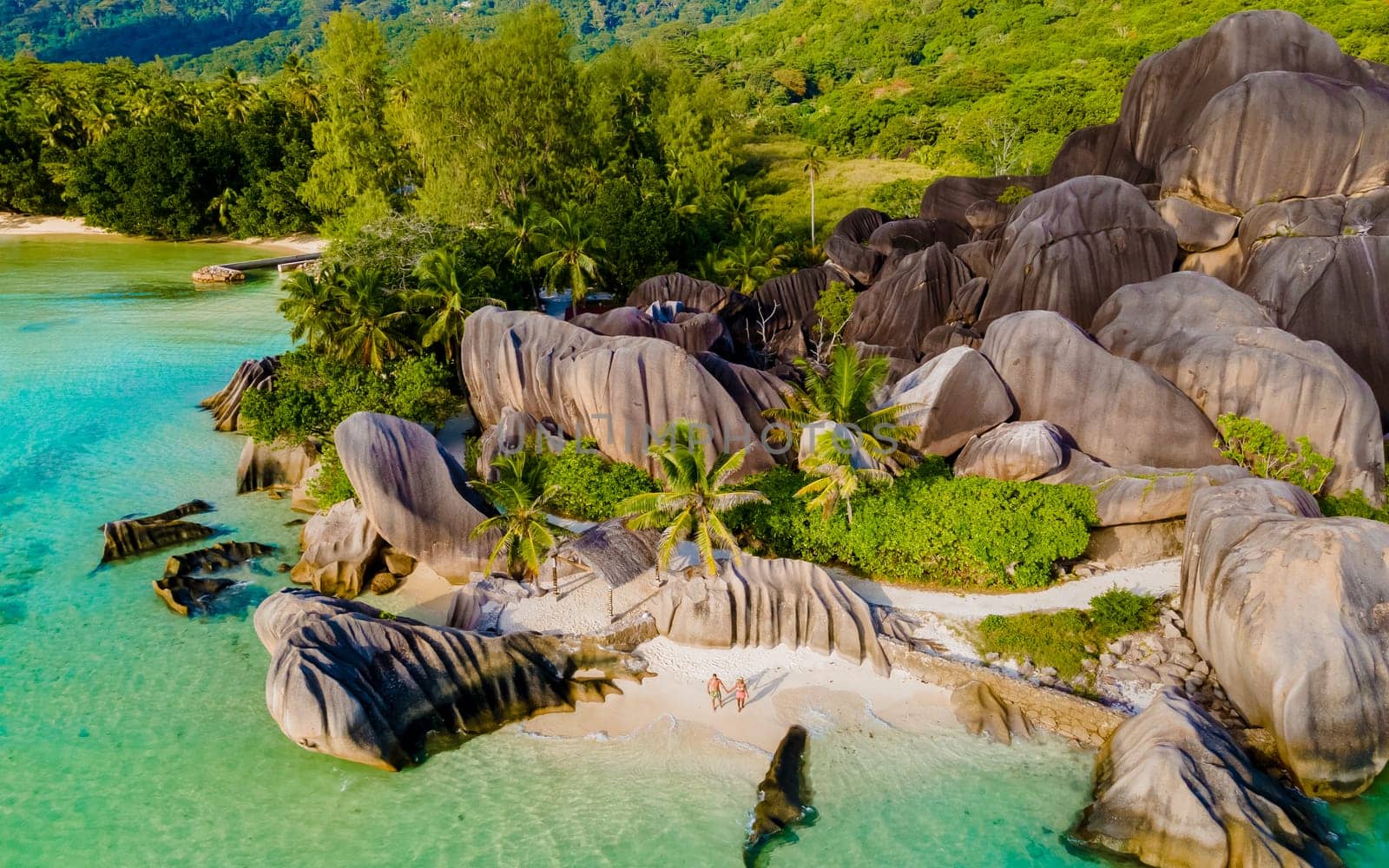 Anse Source d'Argent, La Digue Seychelles, a young couple of men and women on a tropical beach by fokkebok