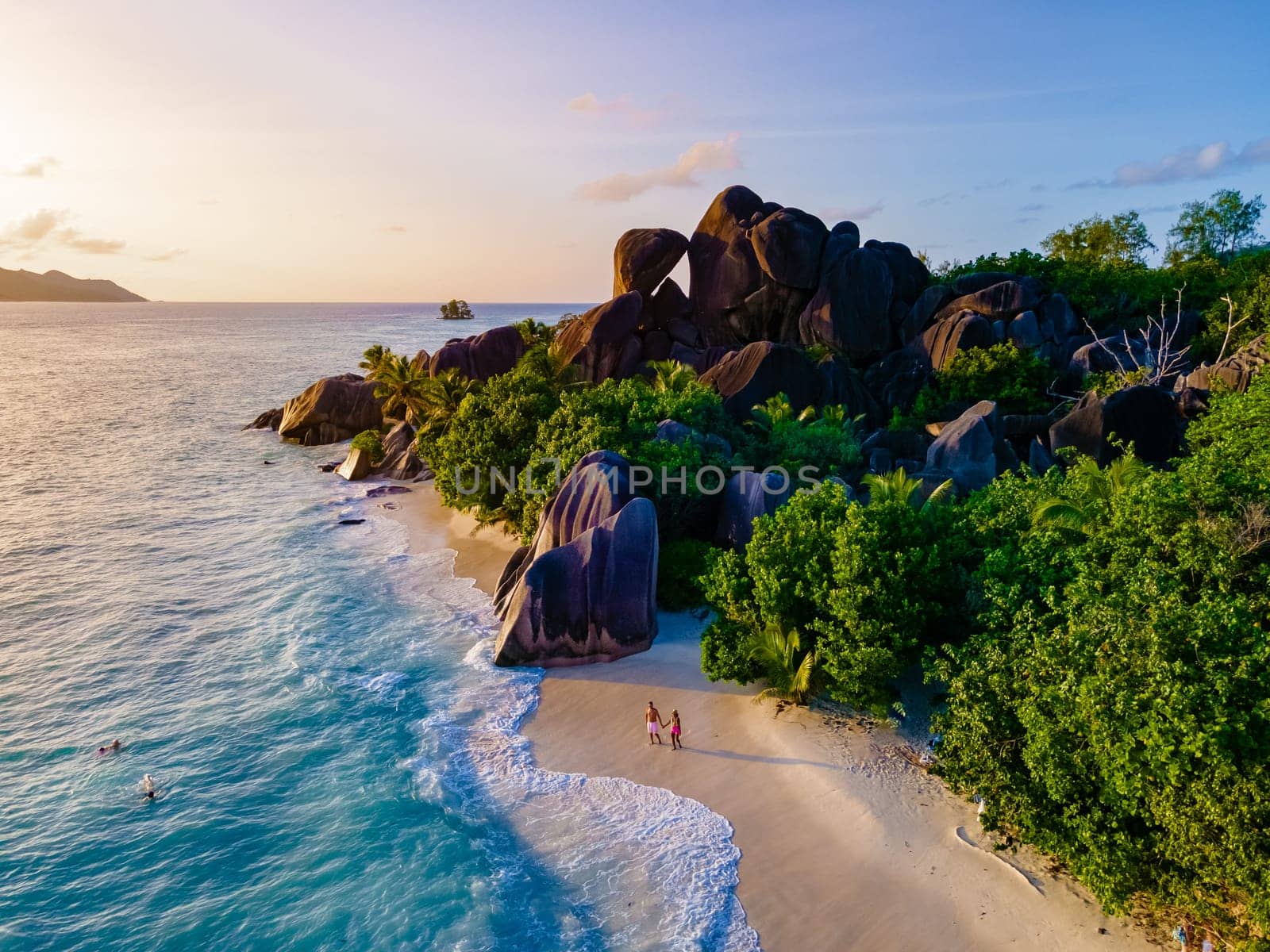 Anse Source d'Argent, La Digue Seychelles, a young couple of men and women on a tropical beach by fokkebok