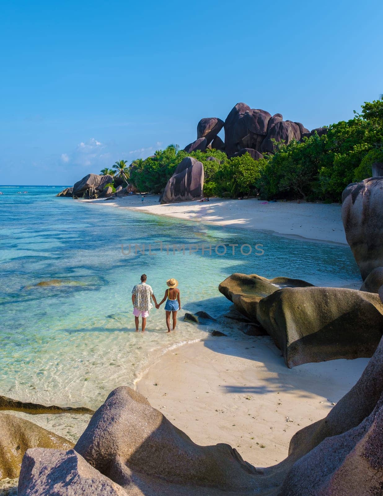 Anse Source d'Argent, La Digue Seychelles, a young couple of men and women on a tropical beach during a luxury vacation in Seychelles. Anse Source d'Argent, La Digue Seychelles