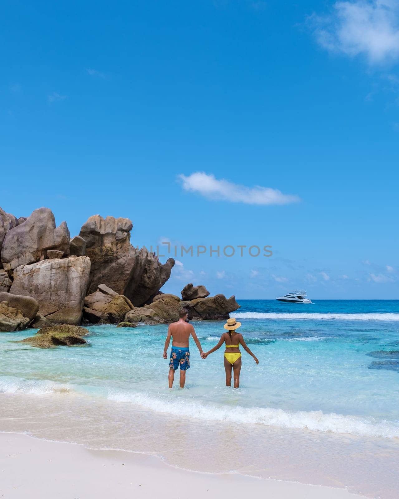 Anse Cocos La Digue Seychelles, a young couple of men and women on a tropical beach during a luxury vacation in Seychelles.