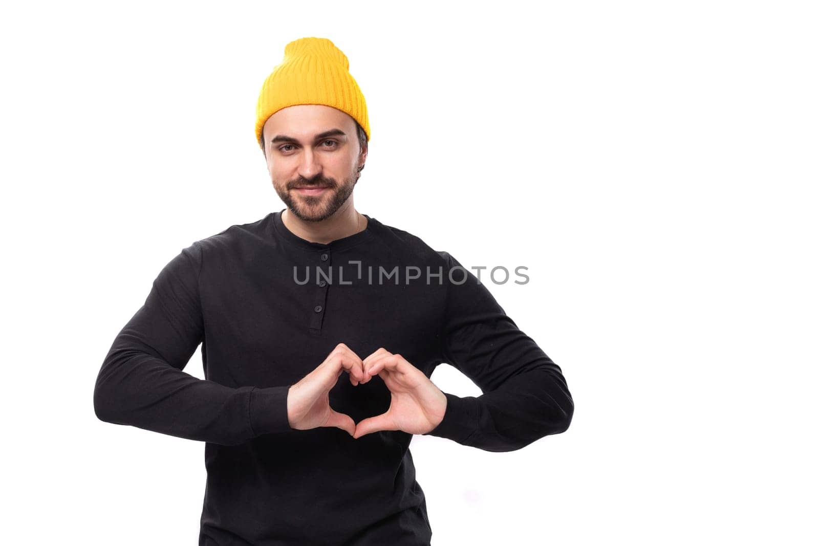 young handsome caucasian brunette man with beard in informal style on white background with copy space by TRMK