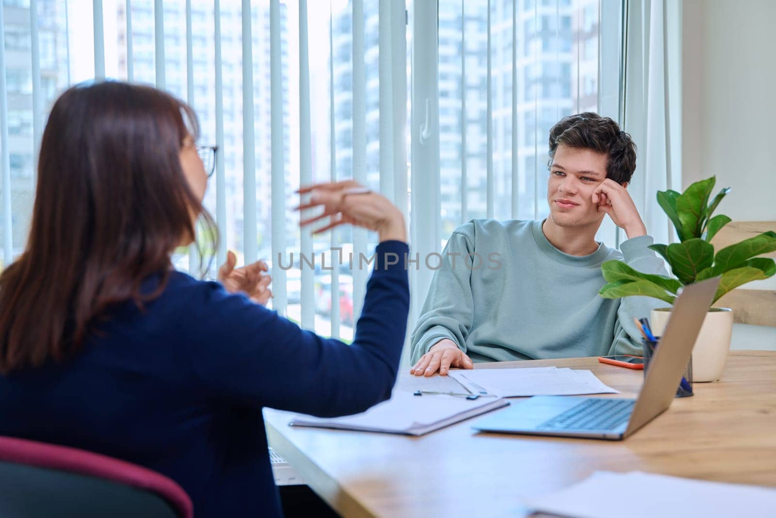 School psychologist, social worker supporting guy student, sitting in office of educational building. Mental health of youth, psychology, psychotherapy, therapy, professional help support