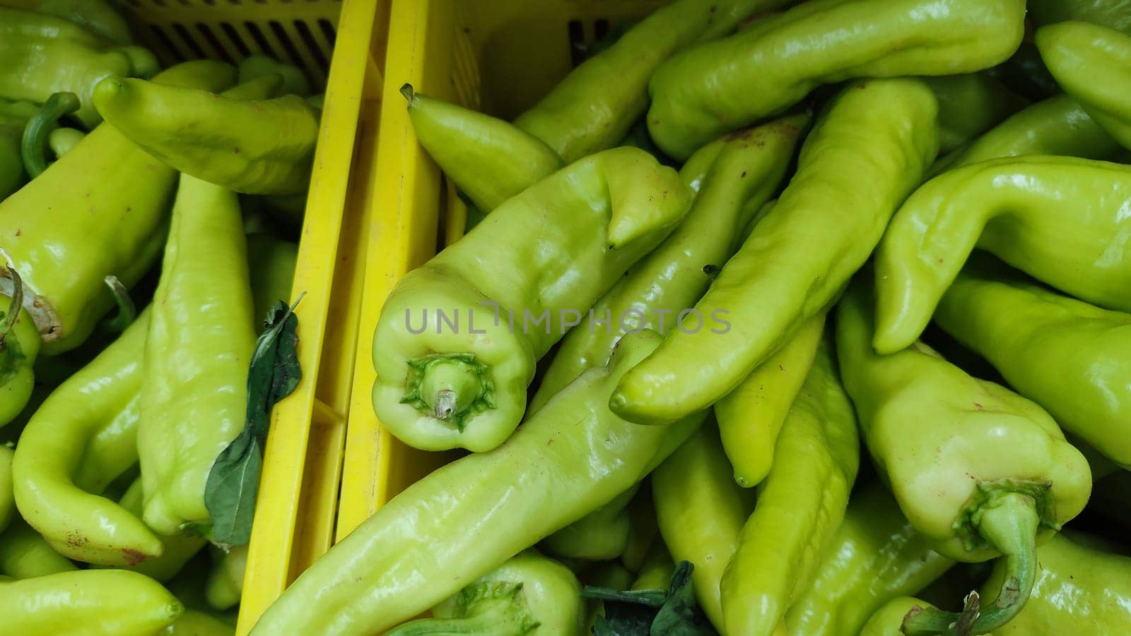 green hot pepper vegetables in yellow plastic boxes , food products. High quality photo
