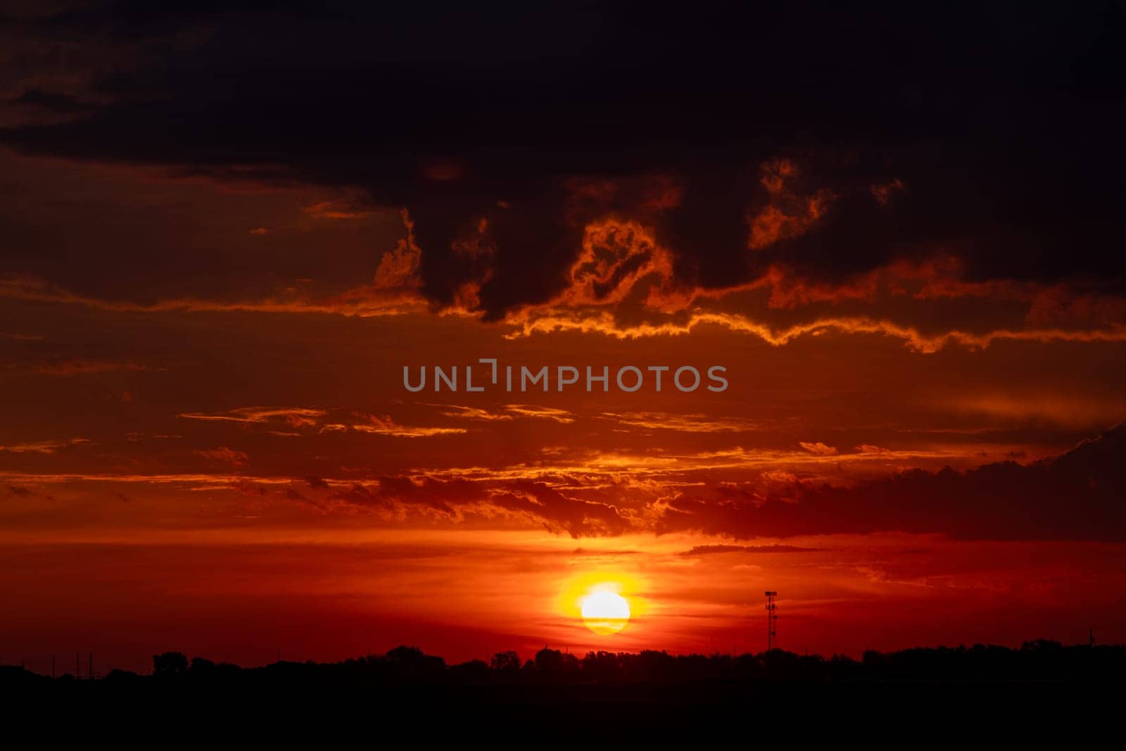 Beautiful Dark Orange sunrise behind clouds over Nebraska by gena_wells