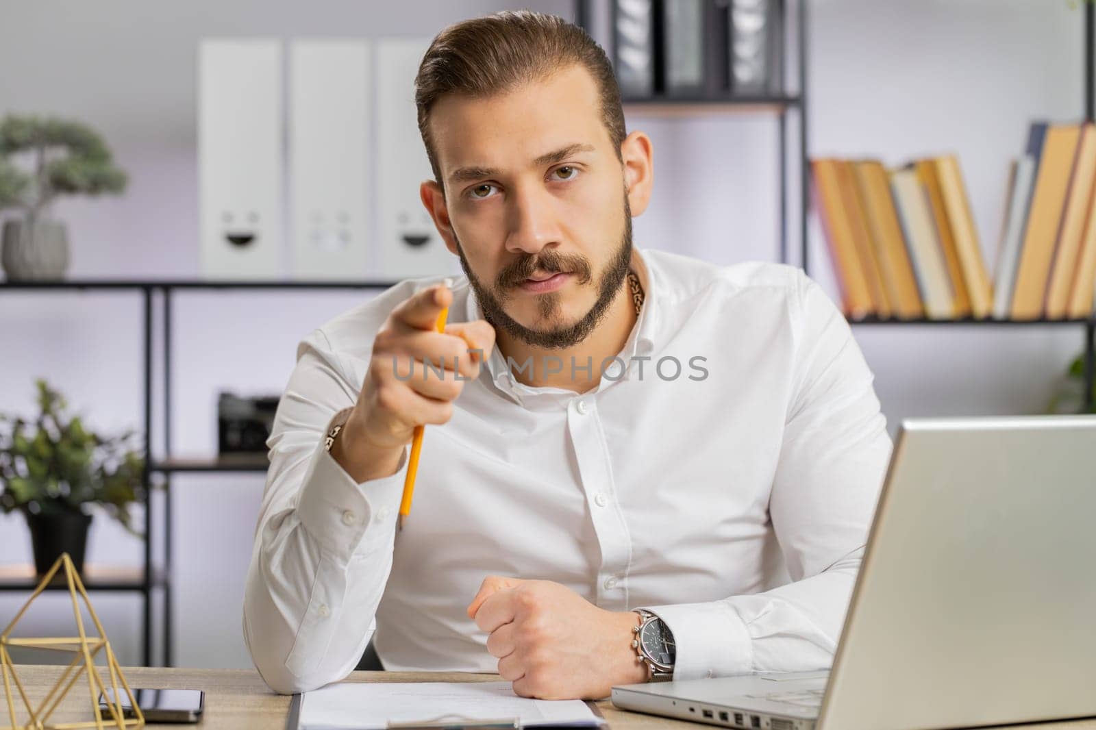 Conflict Quarrel Negotiation. Young angry boss business man making webcam online video call, talking colleague conversation analyzing financial report mistake problem. Guy at office looking at camera