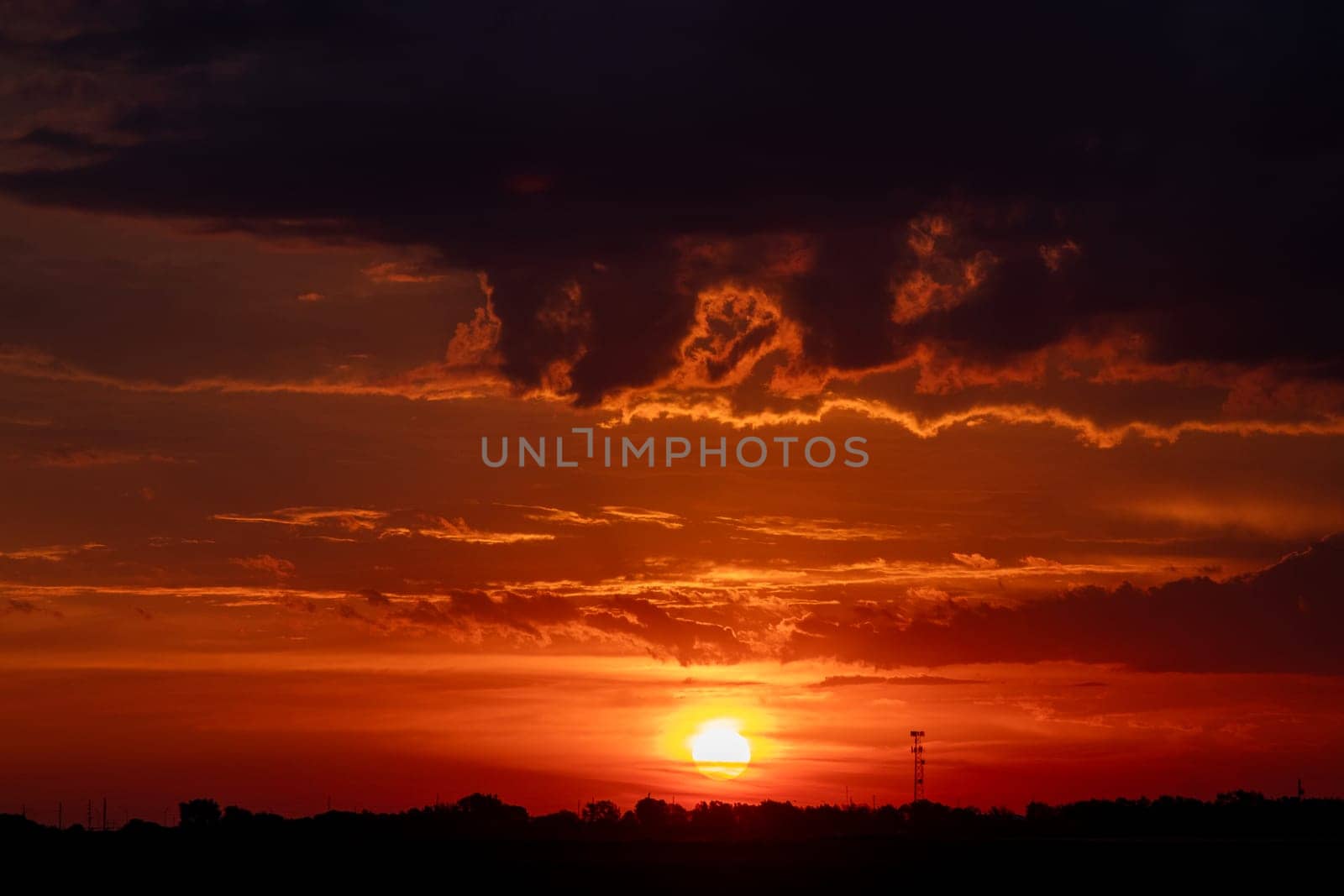 Beautiful Dark Orange sunrise behind clouds over Nebraska . High quality photo