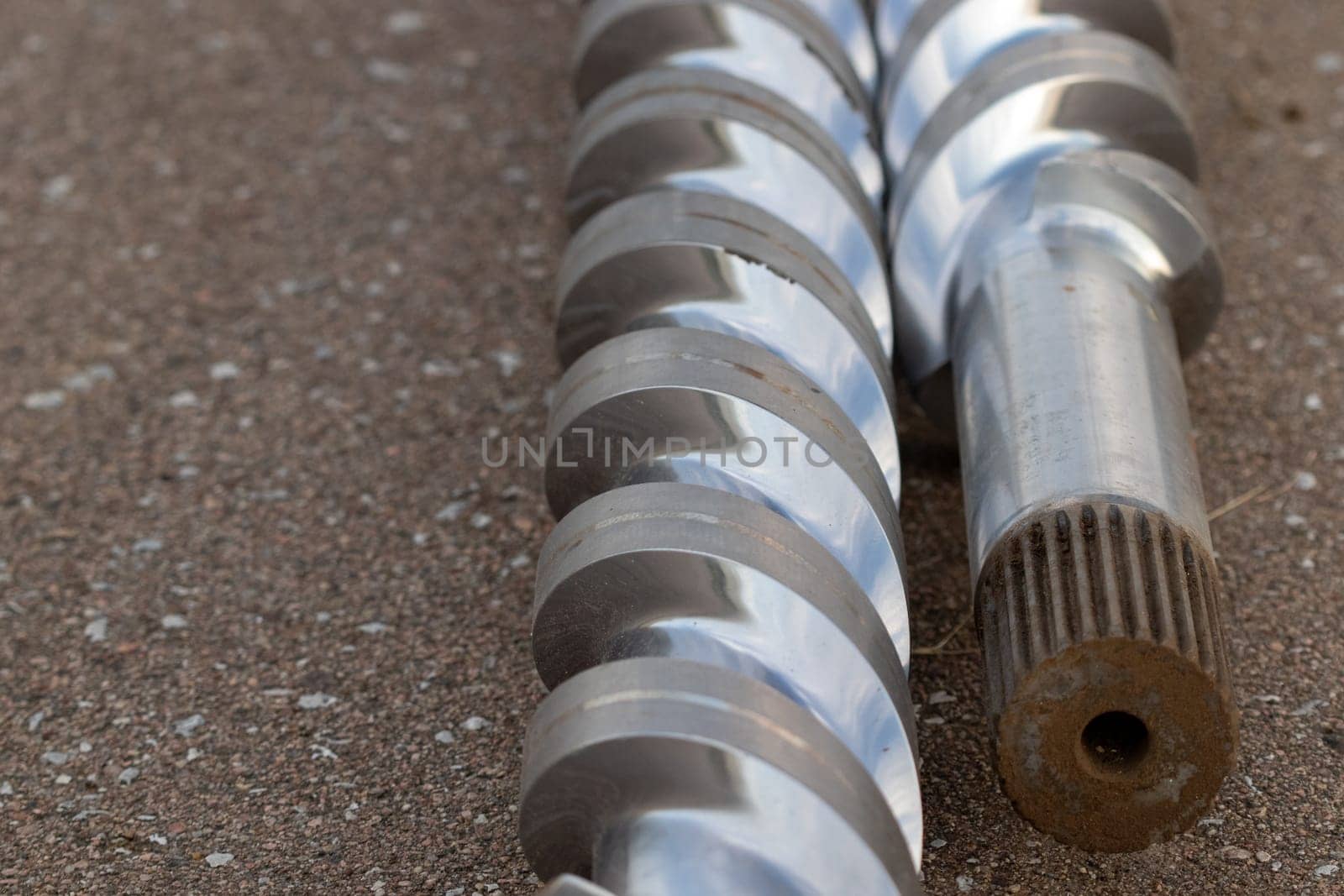 Scrap parts Blending machine screws laying outside . High quality photo