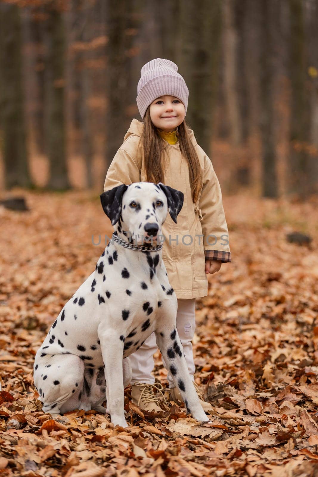 little girl with dog in autumn forest