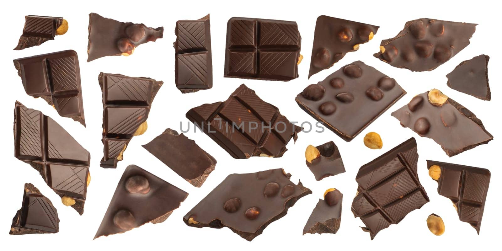 Slices of dark chocolate with nuts on a white isolated background. A set of chocolate that scatters in different directions with nuts of different sizes. Chocolate isolate for advertising banner
