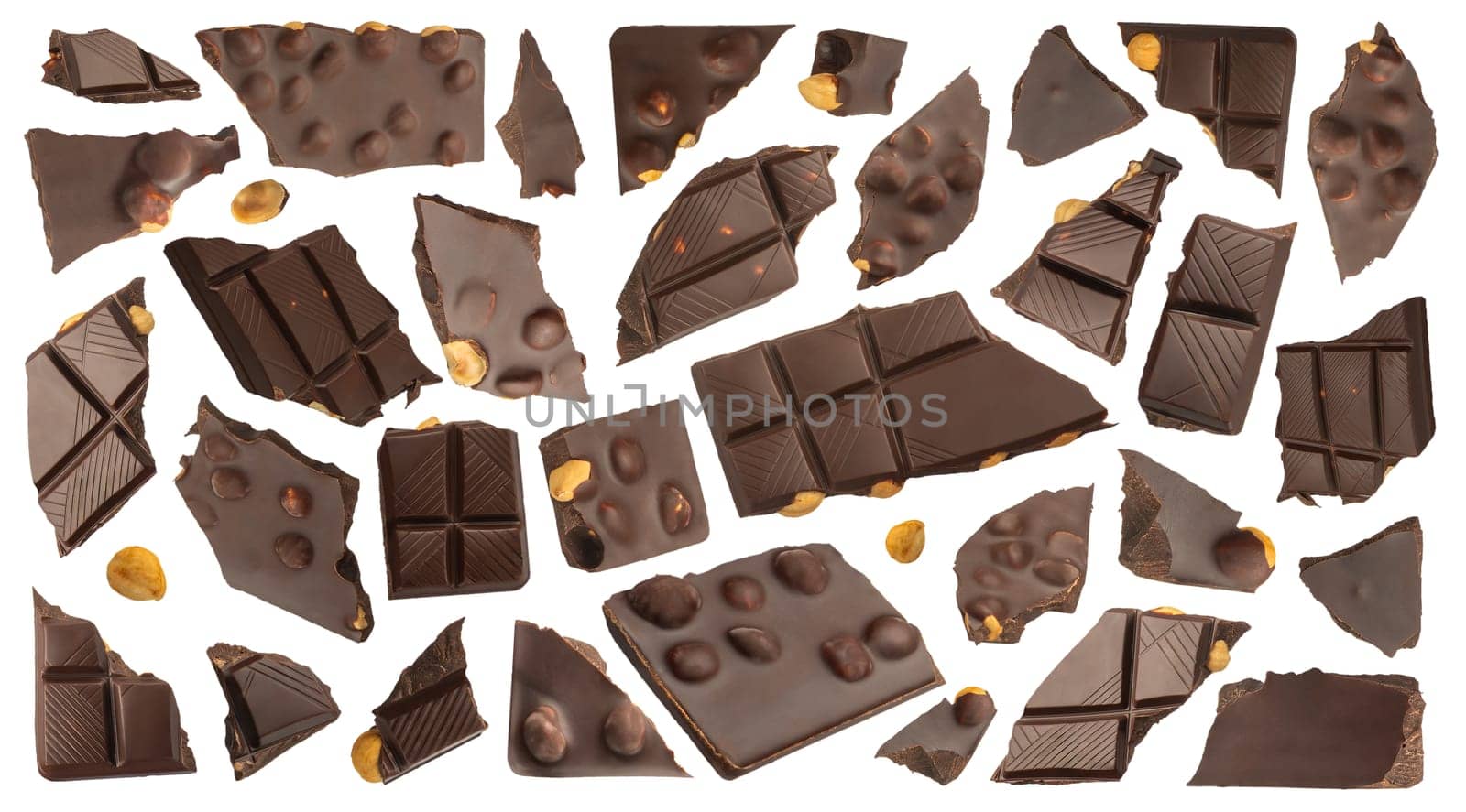 Slices of dark chocolate with nuts on a white isolated background. A set of chocolate that scatters in different directions with nuts of different sizes. Chocolate isolate for advertising banner