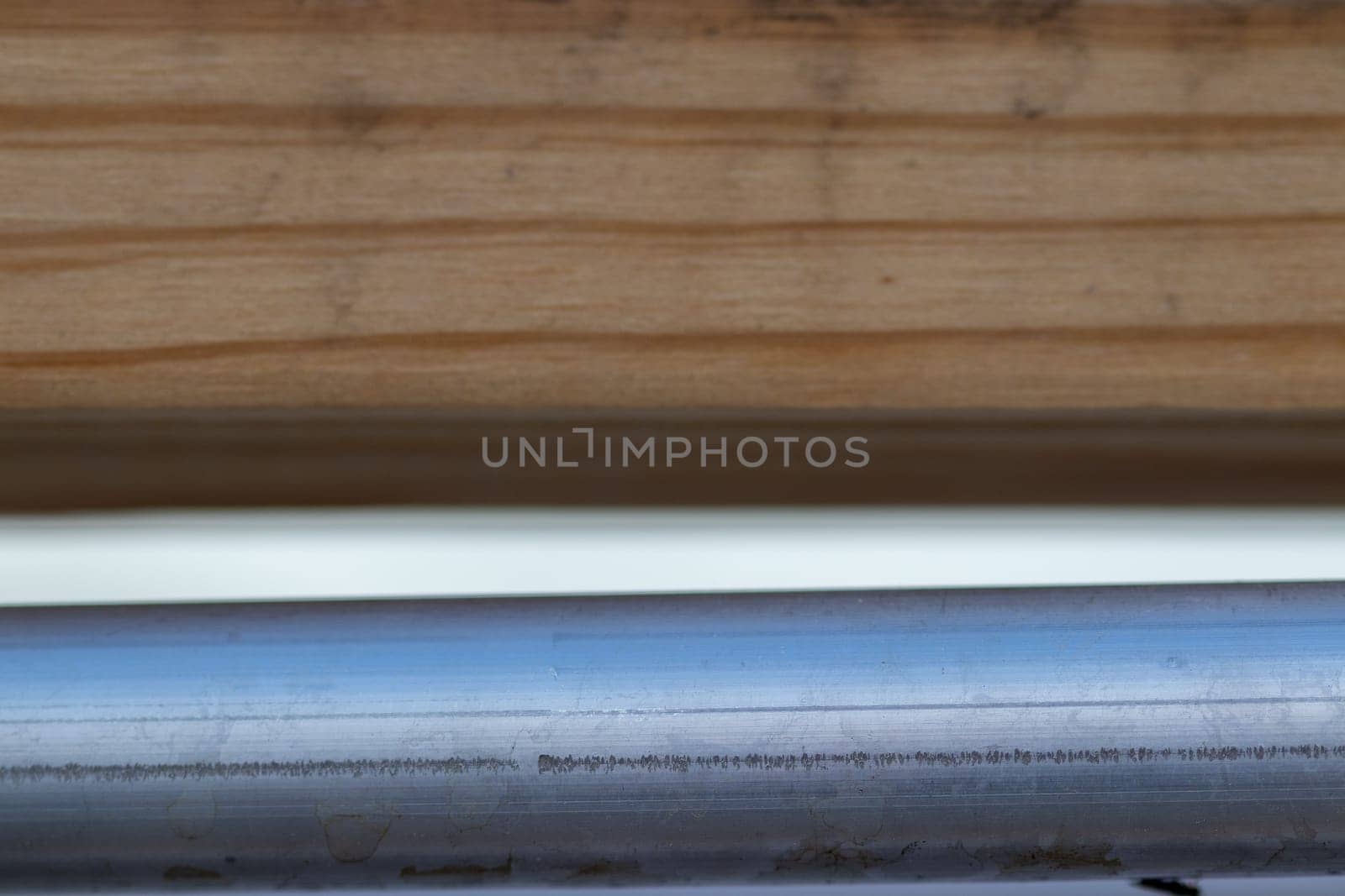close up of metal pipe tube and wood background. High quality photo