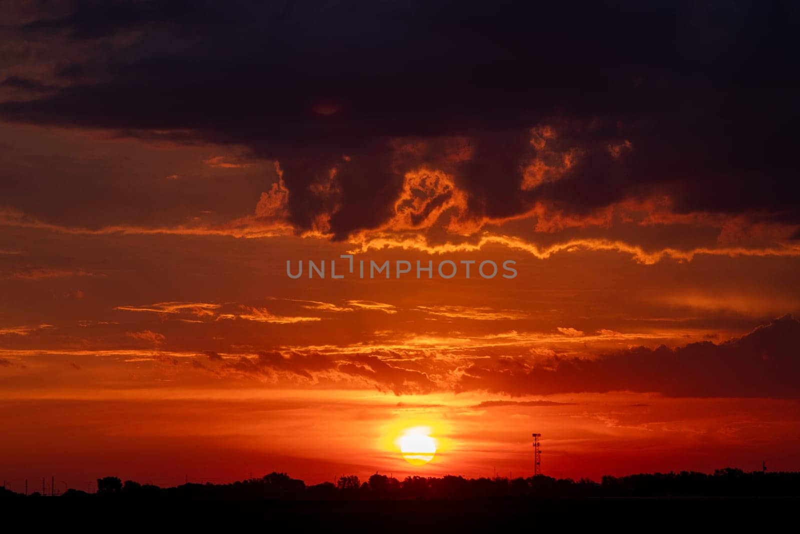 Beautiful Orange sunrise behind clouds over Nebraska . High quality photo