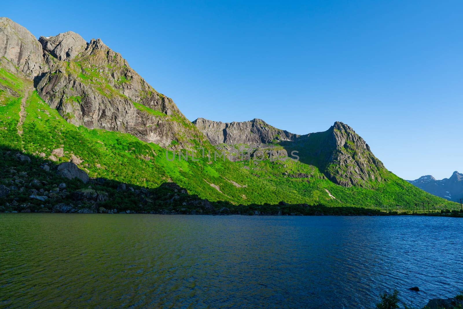 Lofoten Summer Landscape .Lofoten is an archipelago in the county of Nordland, Norway. Is known for a distinctive scenery with dramatic mountains and peaks, sea and ocean.