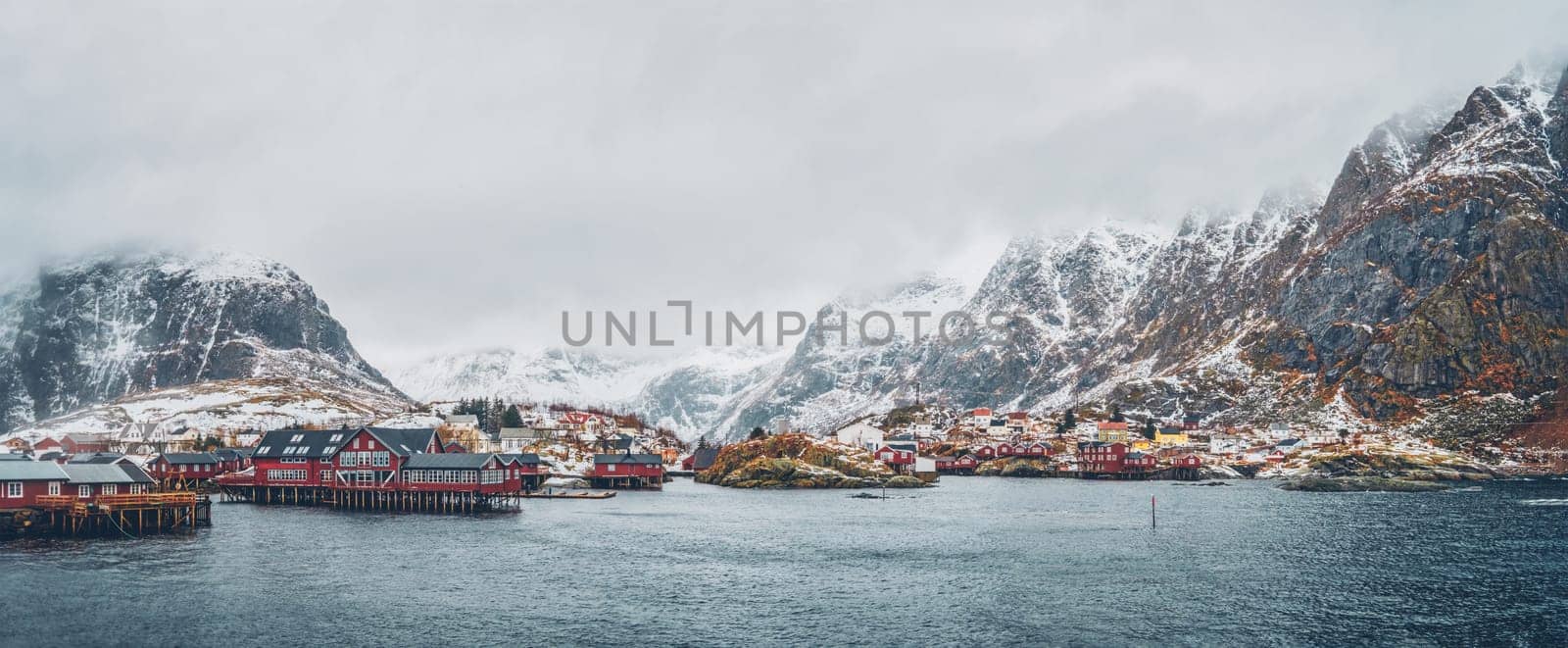 Panorama of traditional fishing village A on Lofoten Islands, Norway with red rorbu houses. With snow in winter