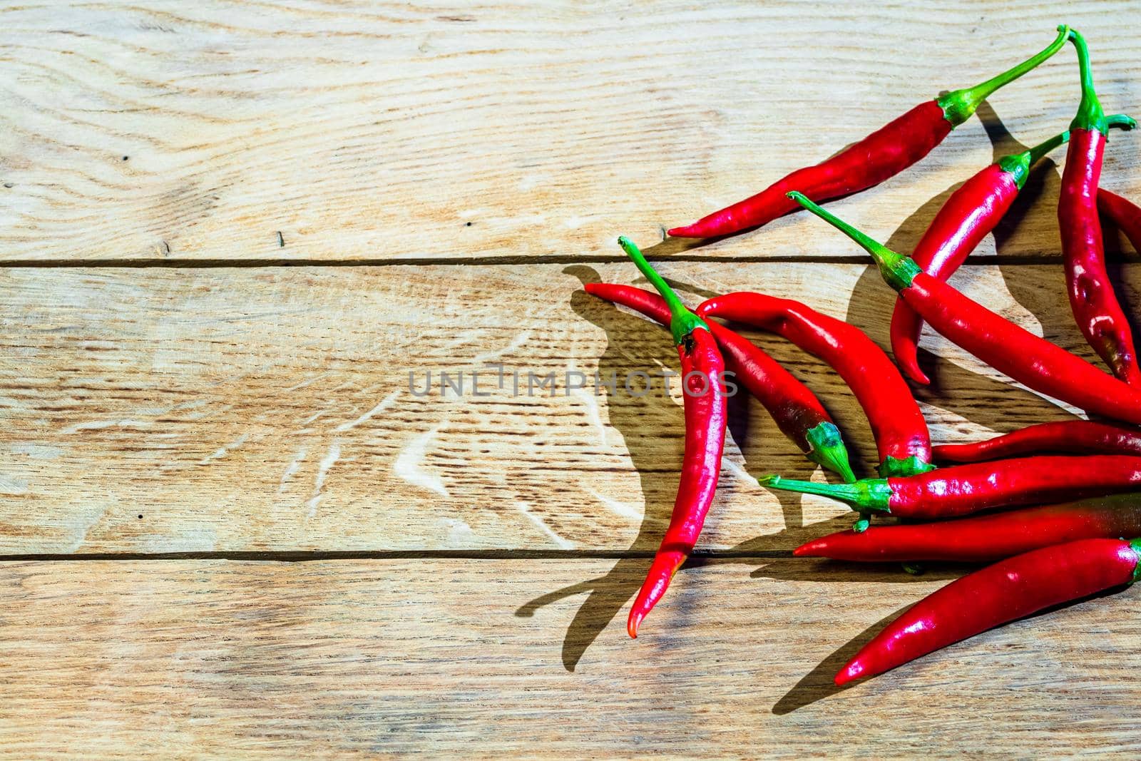 Red hot peppers on wooden table