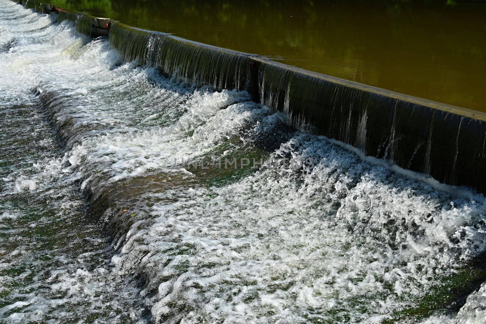 Sluice on the river. Beautiful outdoor nature with running water.