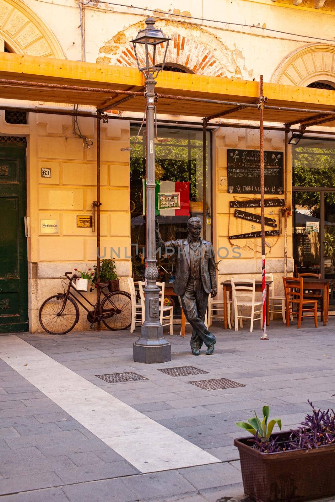 Porto Empedocle, Italy - July 22: The bronze statue of the Sicilian detective Montalbano, character of the television series produced and broadcast by RAI based on the detective novels of Andrea Camilleri on July 22, 2021