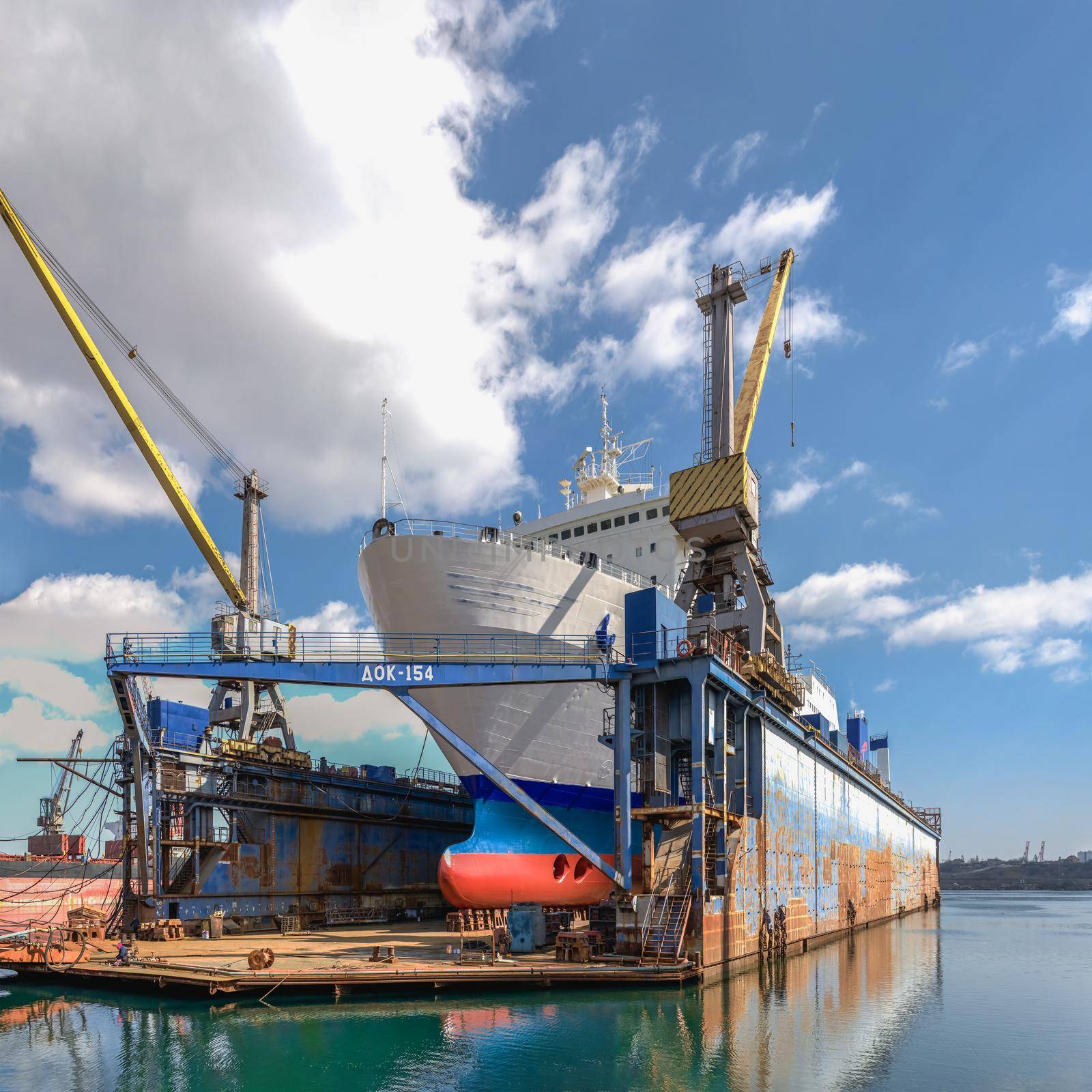 Large ship in dry dock of shipyard by Multipedia