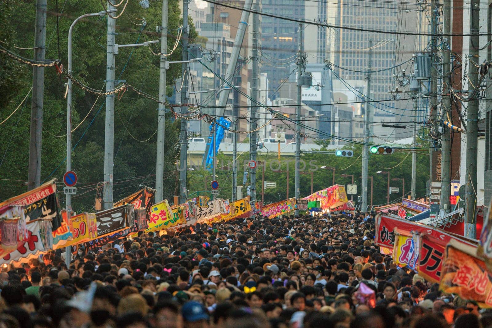 Osaka, Japan - July 25, 2023: Sea of people walk on crowded street at Tenjin Matsuri by Osaze