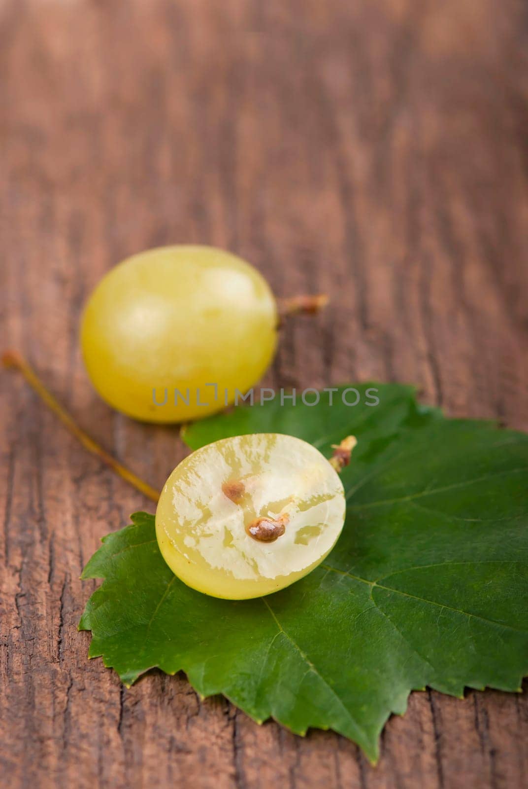 Juicy green grapes - macro shot of whole and cut berries by aprilphoto