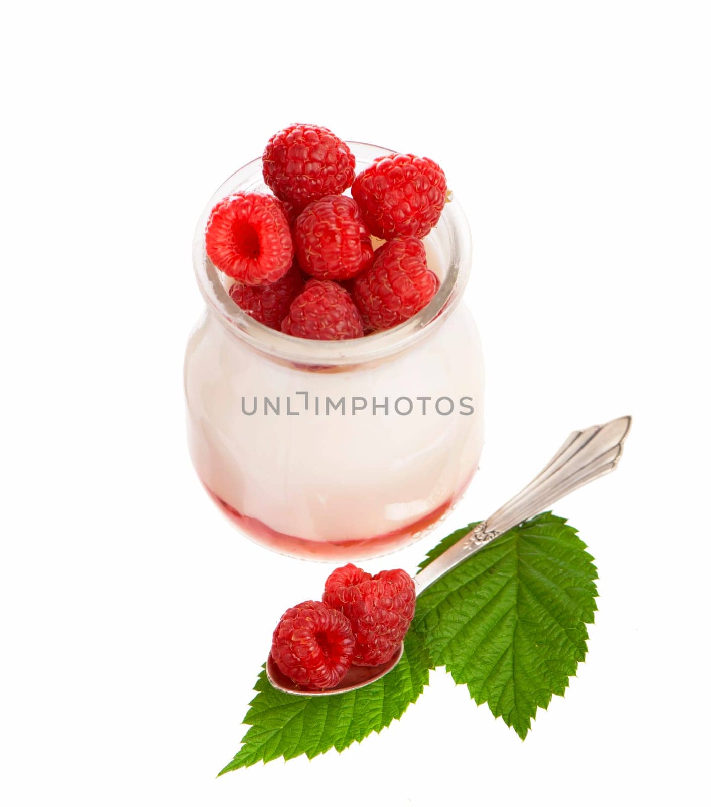 Fresh Yogurt in a jar with Raspberries, leaves on white background