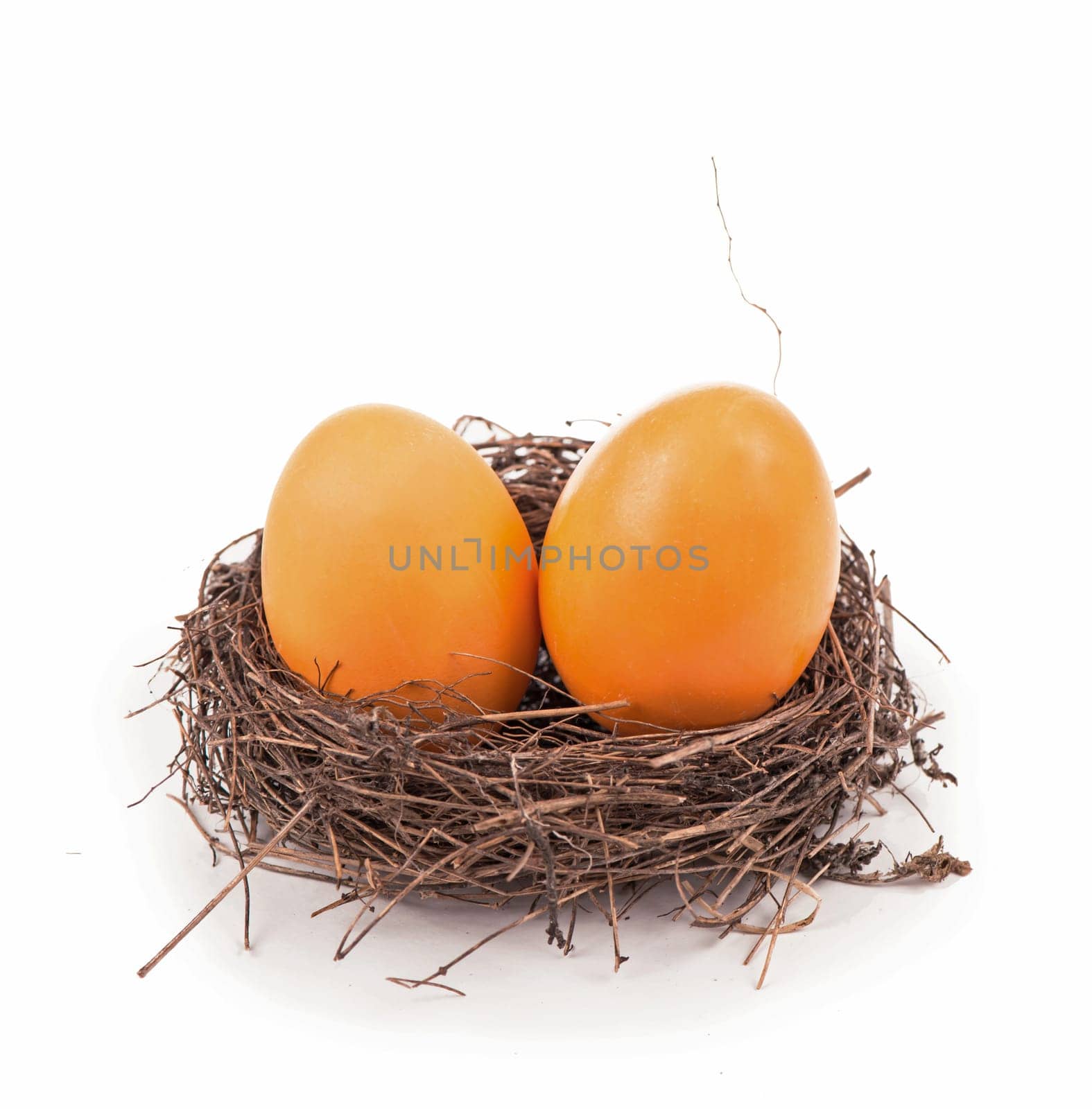 In the nest are eggs painted for Easter. Chicken eggs cooked for Easter in a wicker nest on a white background. Easter nest concept with eggs. by aprilphoto