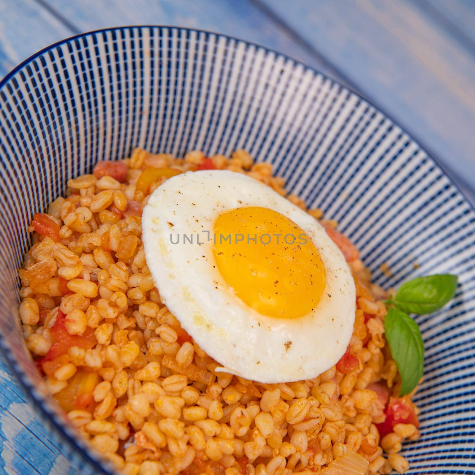 RECIPE FOR BLE WITH BACON, TOMATO AND SHALLOTS, SERVED WITH FRIED EGG. High quality photo