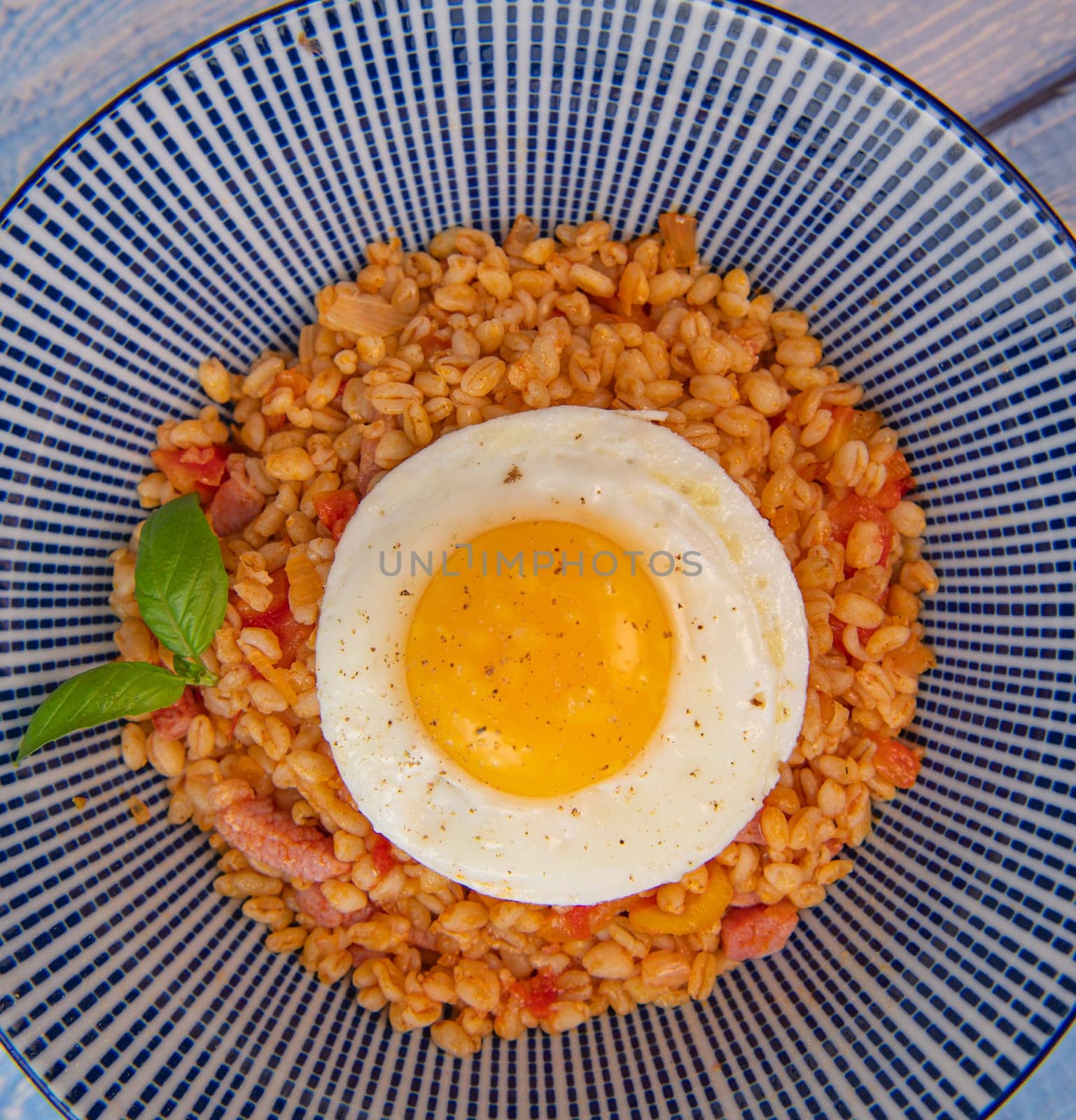 RECIPE FOR BLE WITH BACON, TOMATO AND SHALLOTS, SERVED WITH FRIED EGG. High quality photo