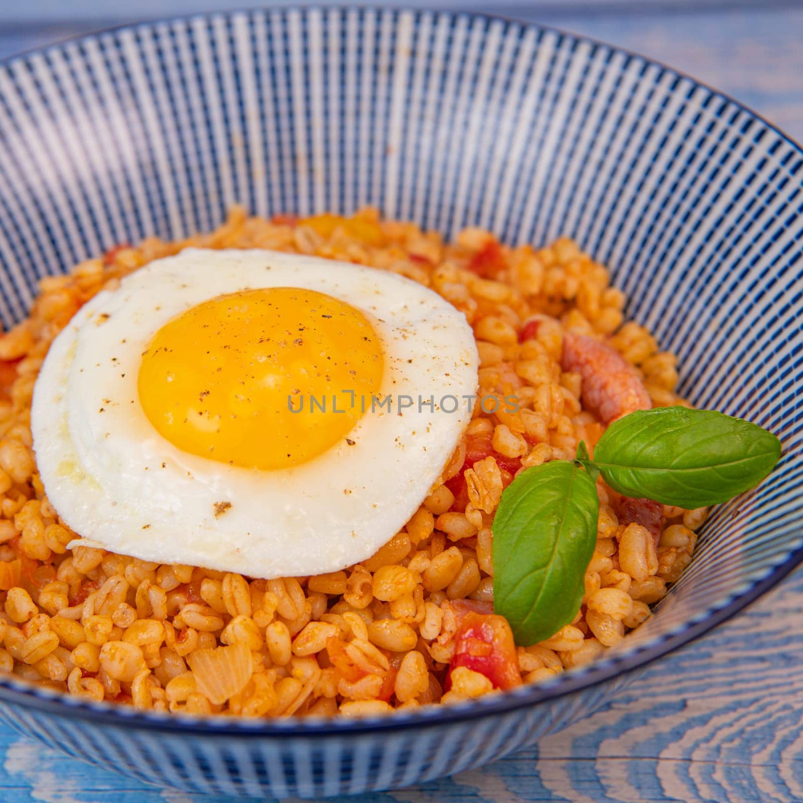 RECIPE FOR BLE WITH BACON, TOMATO AND SHALLOTS, SERVED WITH FRIED EGG. High quality photo