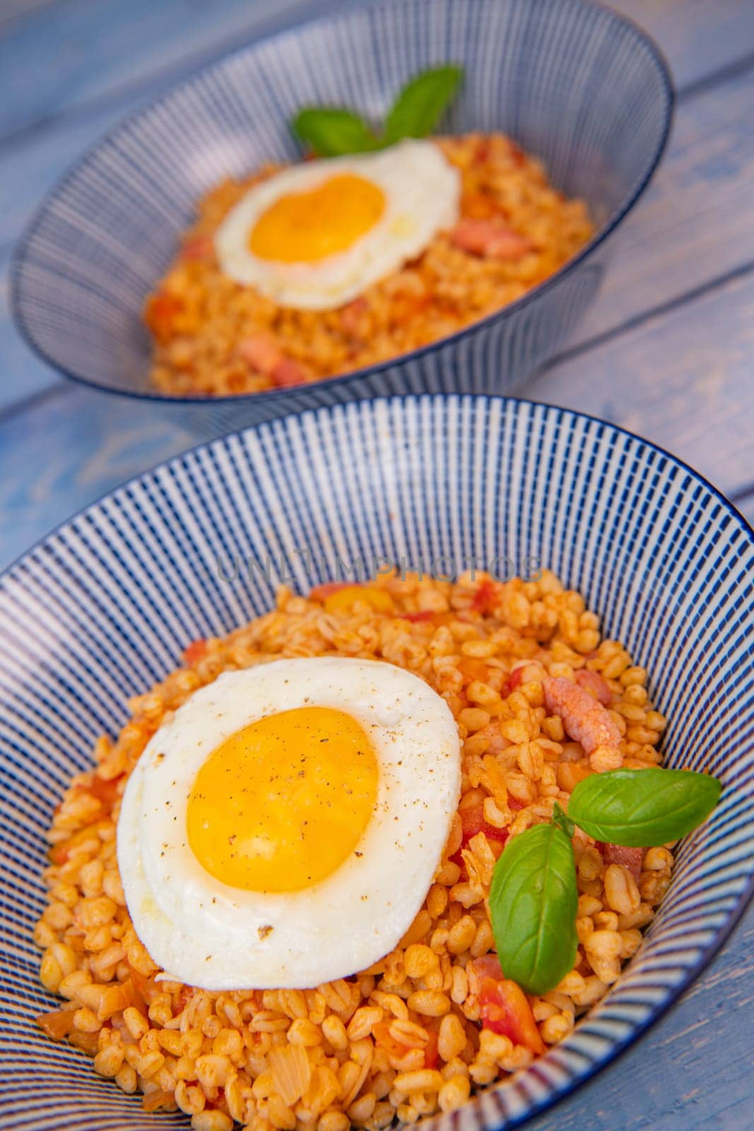 RECIPE FOR BLE WITH BACON, TOMATO AND SHALLOTS, SERVED WITH FRIED EGG. High quality photo