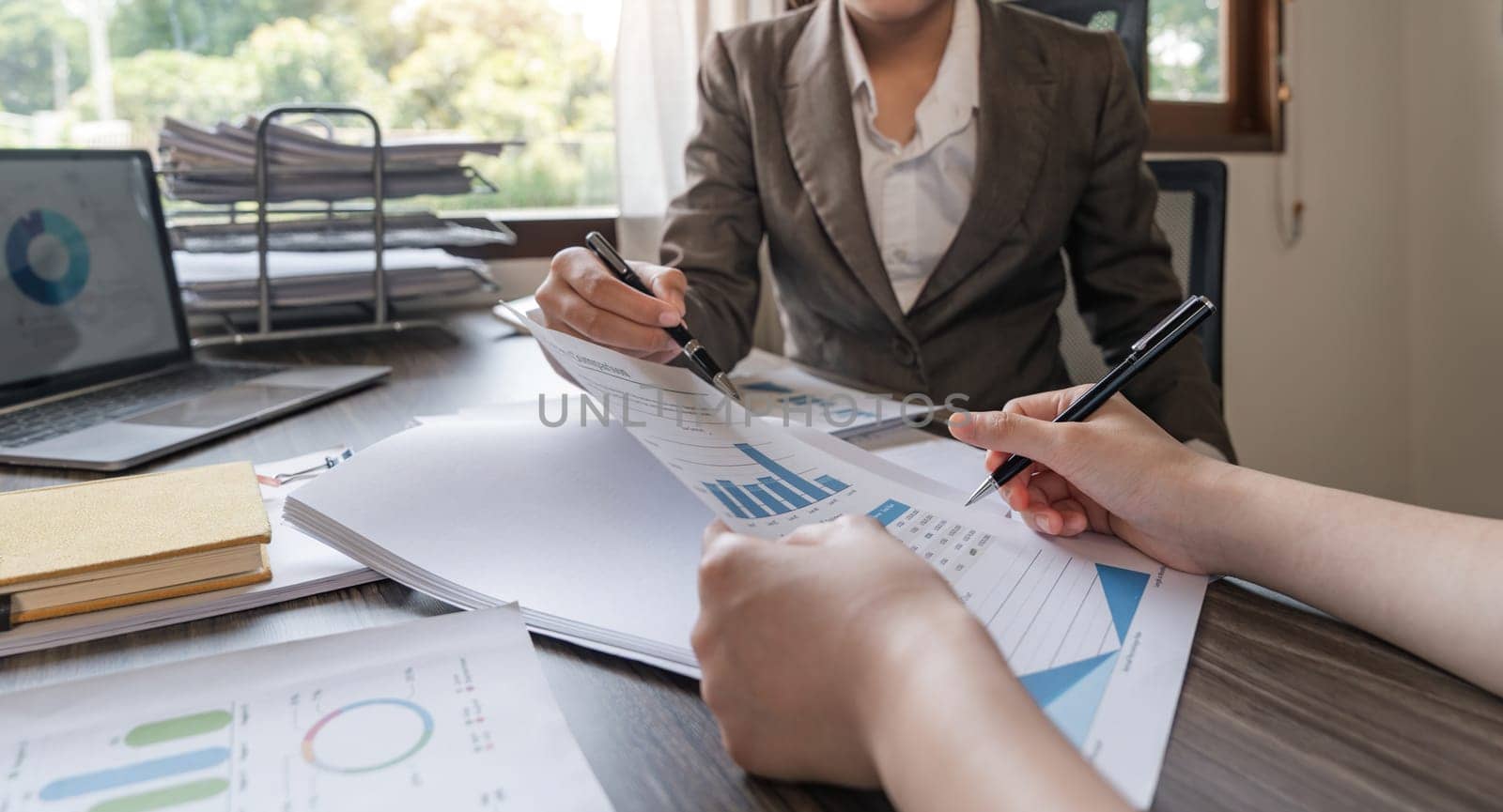 Two businessmen discussion analysis sharing calculations about the company budget and financial planning together on desk at the office room by nateemee