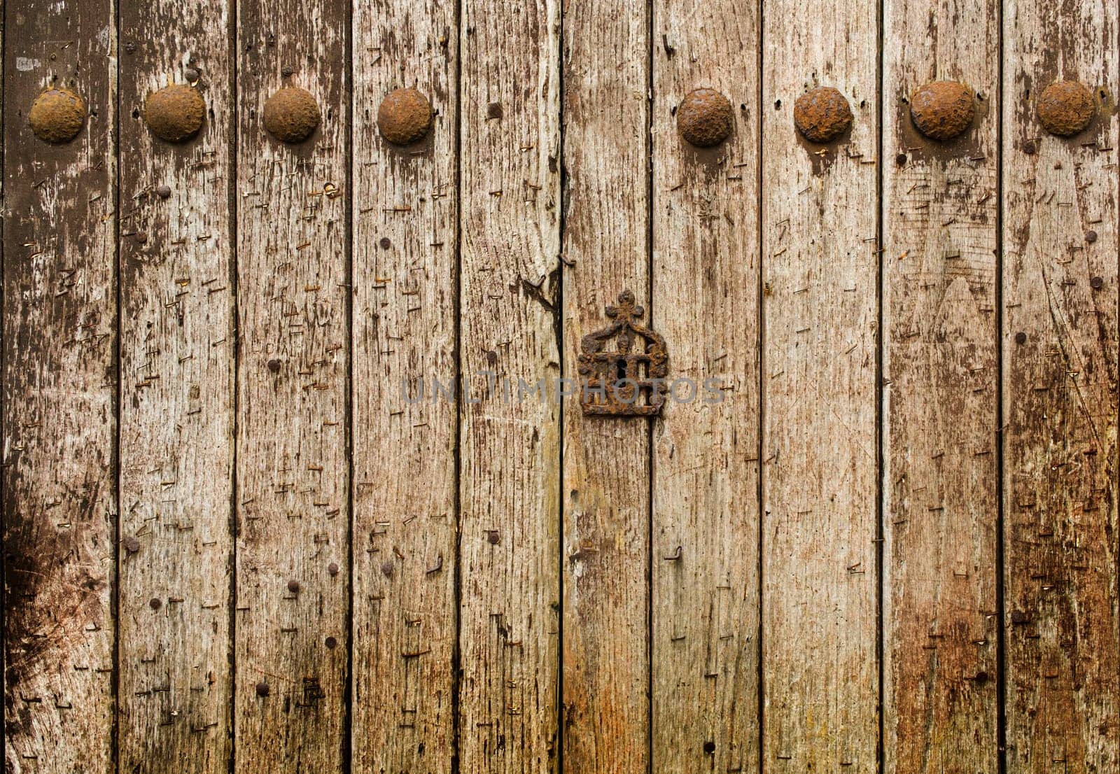 Very old wooden door with a lot of texture and rusty iron nails. by csbphoto