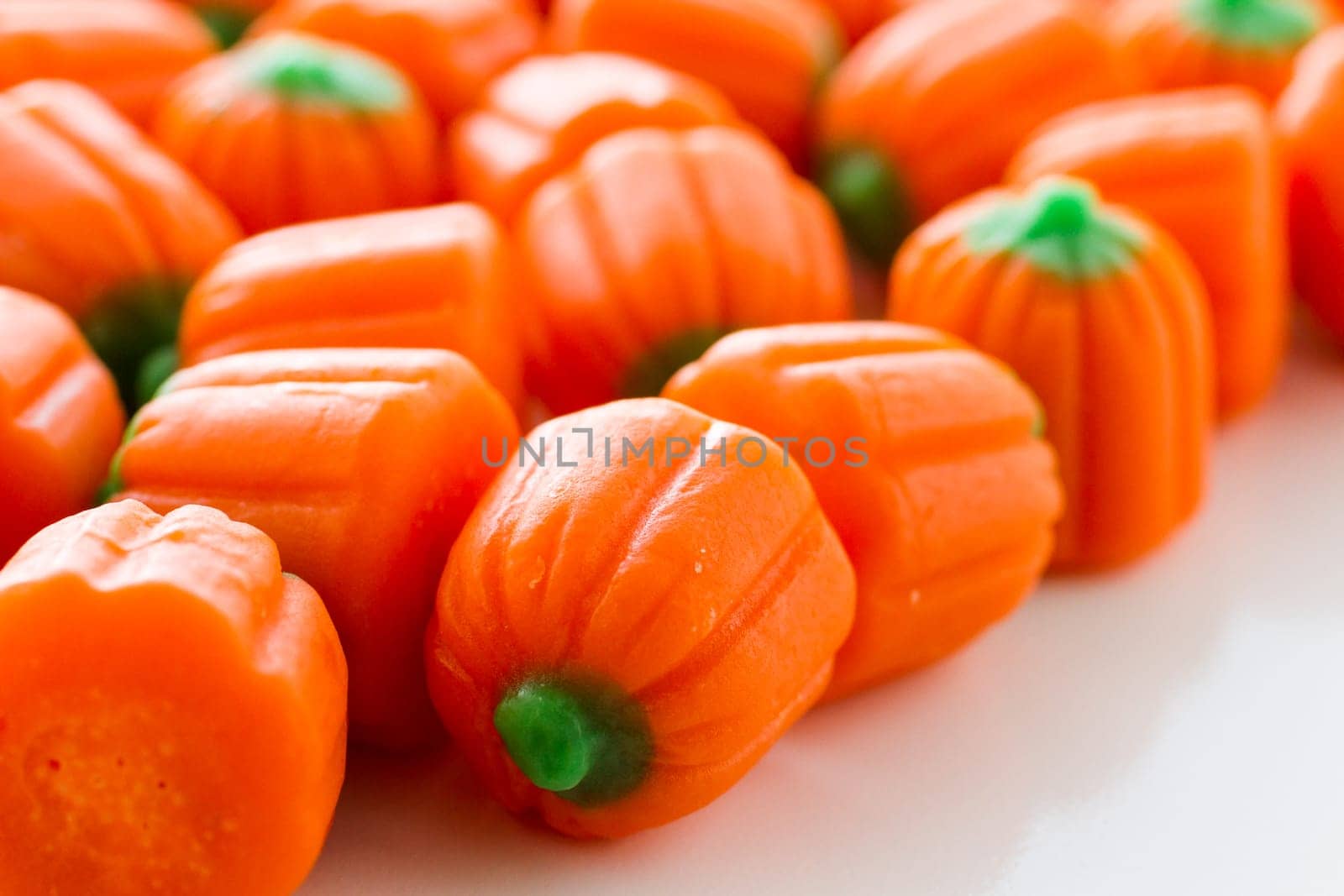 Halloween candy pumpkins in a pile.