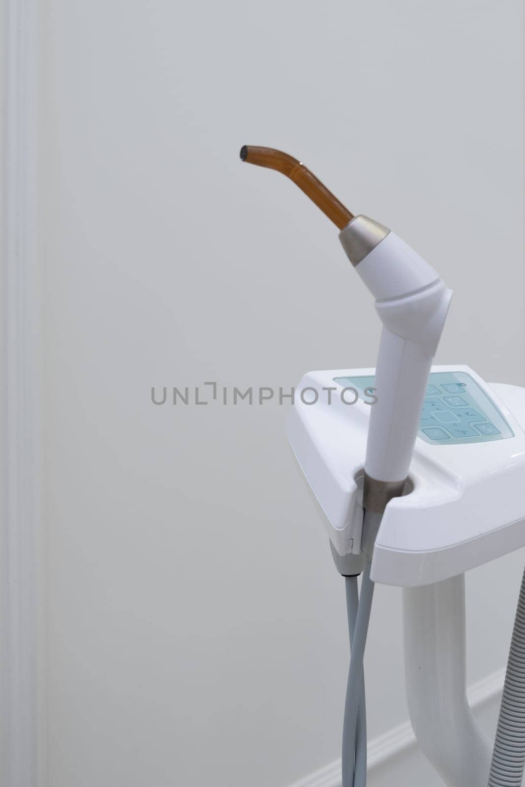 Dental UV curing lamp for polymerization of dental materials. Healthcare concept. Blue light concept.