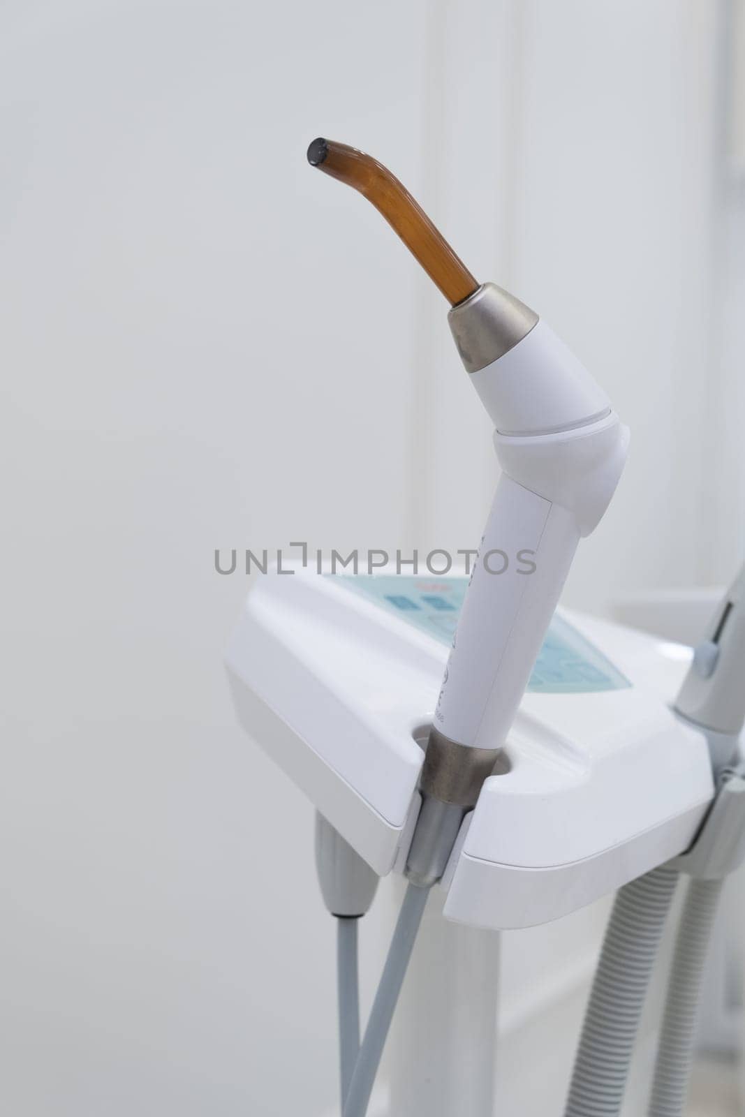 Dental UV curing lamp for polymerization of dental materials. Healthcare concept. Blue light concept.