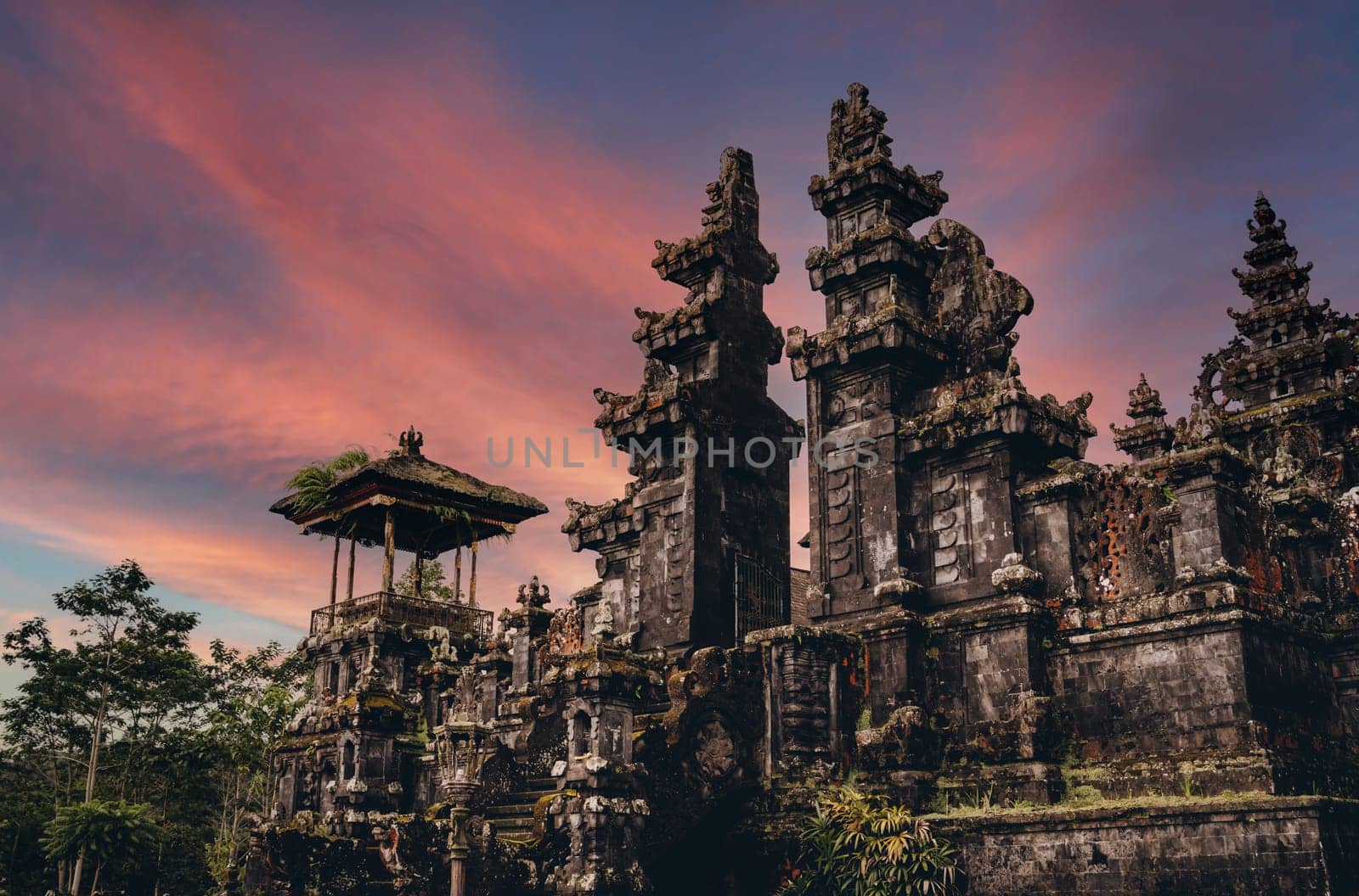 Magnific landscape view of besakih temple with fiery beautiful sky. Sacred balinese temple with traditional architecture